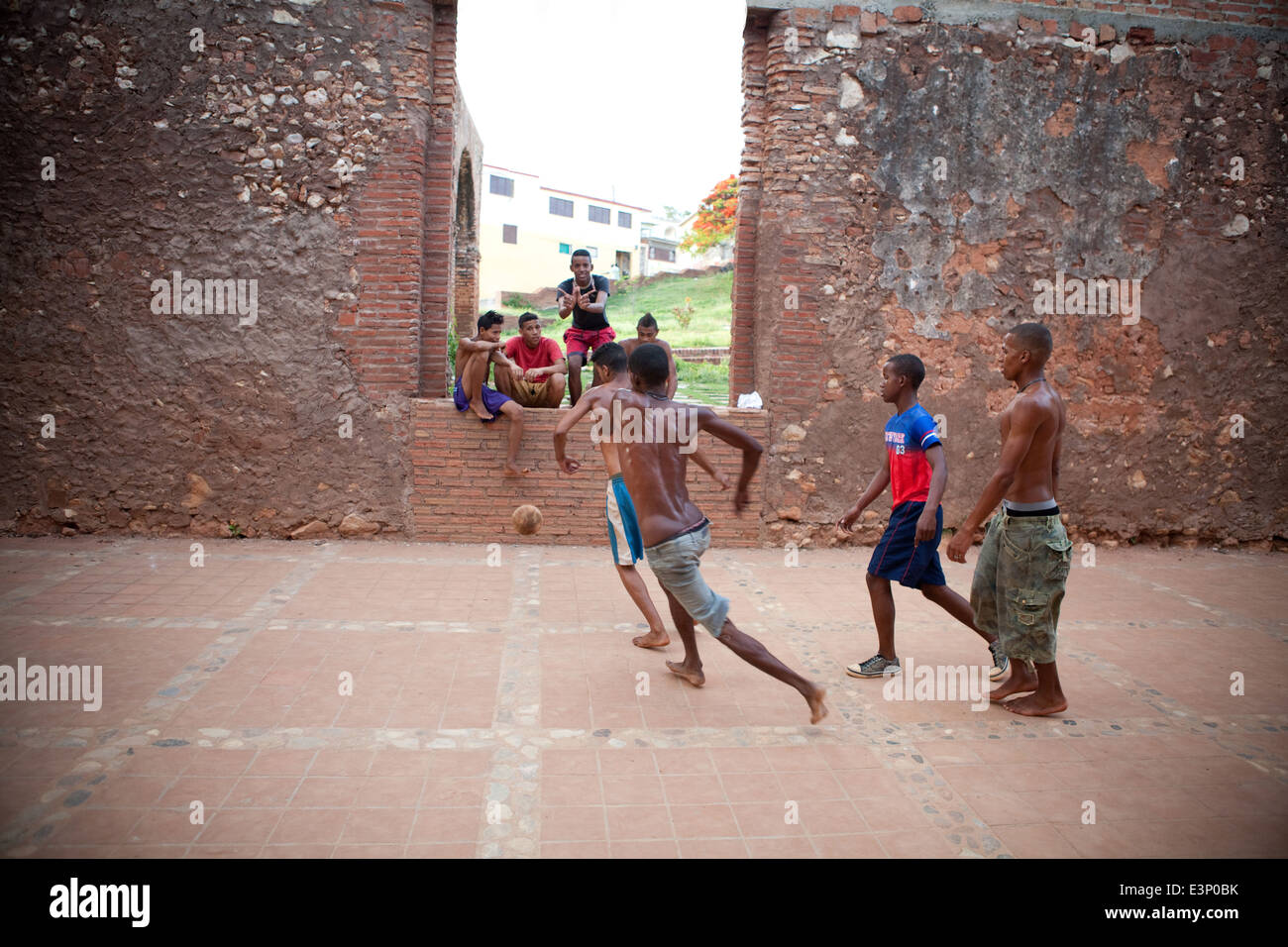 Boys playing soccer in the remains of a church. Trinidad, Cuba Stock Photo