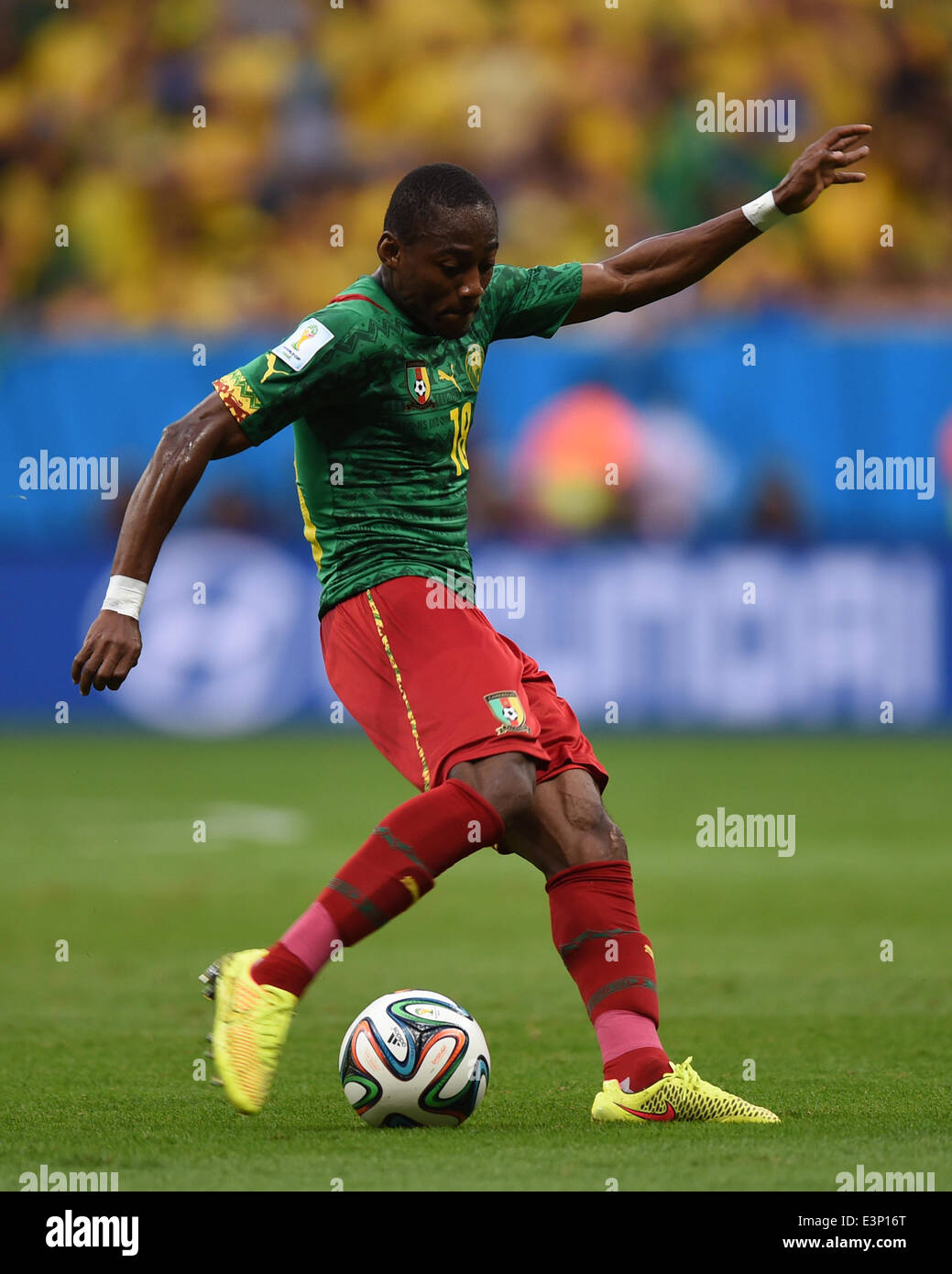 Cameroon's Eyong Enoh controls the ball during the FIFA World Cup 2014 group A preliminary round match between Cameroon and Brazil at the Estadio Nacional in Brasilia, Brazil, 23 June 2014. Photo: Marius Becker/dpa (RESTRICTIONS APPLY: Editorial Use Only, not used in association with any commercial entity - Images must not be used in any form of alert service or push service of any kind including via mobile alert services, downloads to mobile devices or MMS messaging - Images must appear as still images and must not emulate match action video footage - No alteration is made to, and no text or  Stock Photo