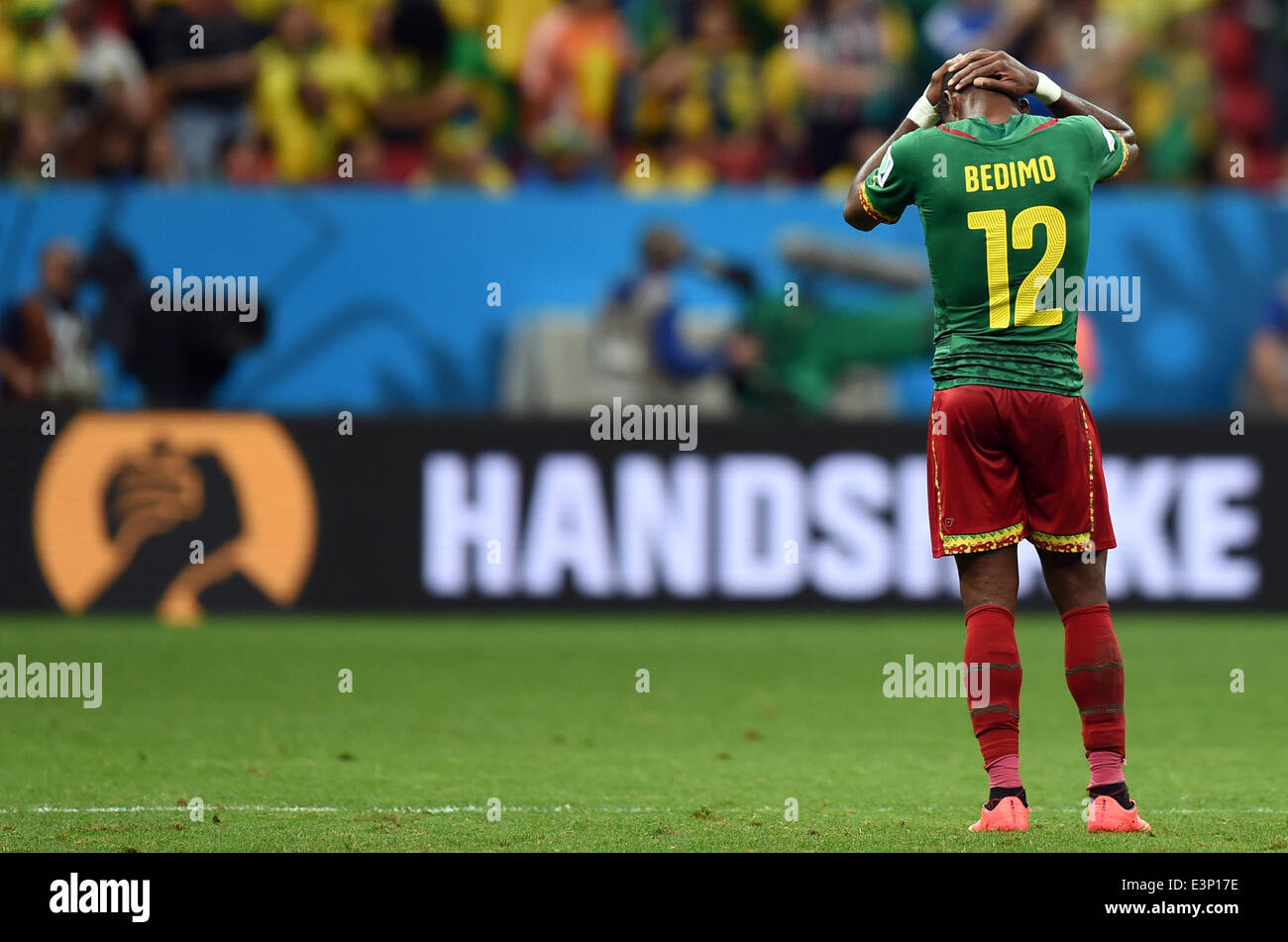 Cameroon's Henri Bedimo reacts during the FIFA World Cup 2014 group A preliminary round match between Cameroon and Brazil at the Estadio Nacional in Brasilia, Brazil, 23 June 2014. Photo: Marius Becker/dpa (RESTRICTIONS APPLY: Editorial Use Only, not used in association with any commercial entity - Images must not be used in any form of alert service or push service of any kind including via mobile alert services, downloads to mobile devices or MMS messaging - Images must appear as still images and must not emulate match action video footage - No alteration is made to, and no text or image is  Stock Photo