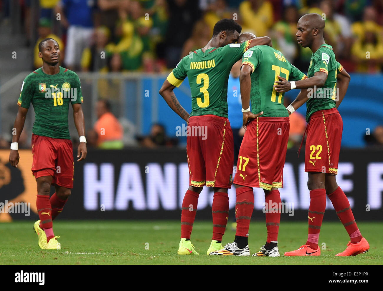 Cameroon's Eyong Enoh (L-R), Nicolas Nkoulou, Stephane Mbia and Allan Nyom react during the FIFA World Cup 2014 group A preliminary round match between Cameroon and Brazil at the Estadio Nacional in Brasilia, Brazil, 23 June 2014. Photo: Marius Becker/dpa (RESTRICTIONS APPLY: Editorial Use Only, not used in association with any commercial entity - Images must not be used in any form of alert service or push service of any kind including via mobile alert services, downloads to mobile devices or MMS messaging - Images must appear as still images and must not emulate match action video footage -  Stock Photo