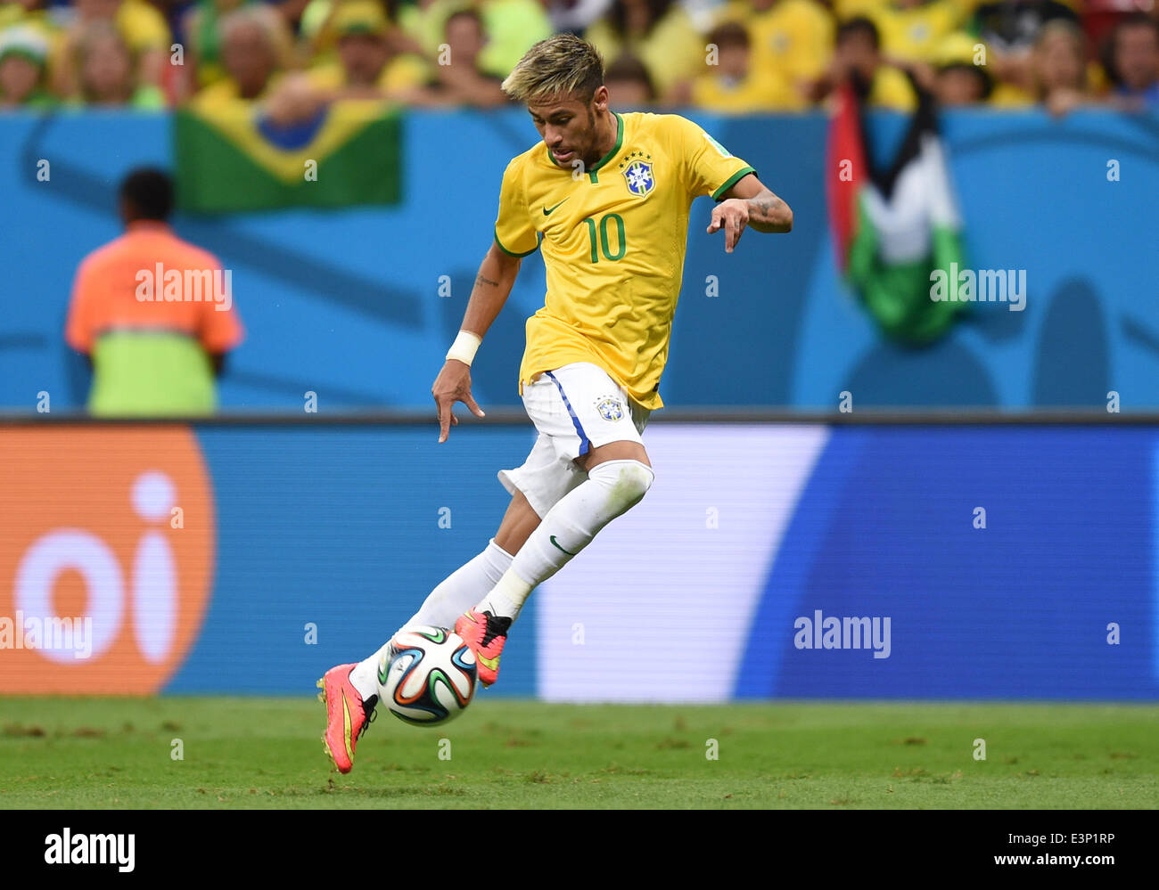 Brazil's Neymar plays the ball during the FIFA World Cup 2014 group A preliminary round match between Cameroon and Brazil at the Estadio Nacional in Brasilia, Brazil, 23 June 2014. Photo: Marius Becker/dpa (RESTRICTIONS APPLY: Editorial Use Only, not used in association with any commercial entity - Images must not be used in any form of alert service or push service of any kind including via mobile alert services, downloads to mobile devices or MMS messaging - Images must appear as still images and must not emulate match action video footage - No alteration is made to, and no text or image is  Stock Photo
