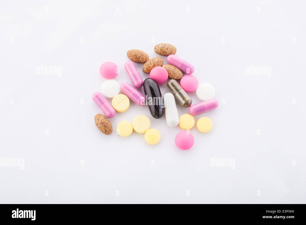 many colorful pills on a white background. symbolic photo for medicine and drugs Stock Photo