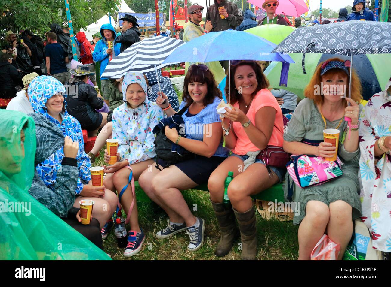 Glastonbury Festival, 26th June, 2014 Festival goers sit in the heavy