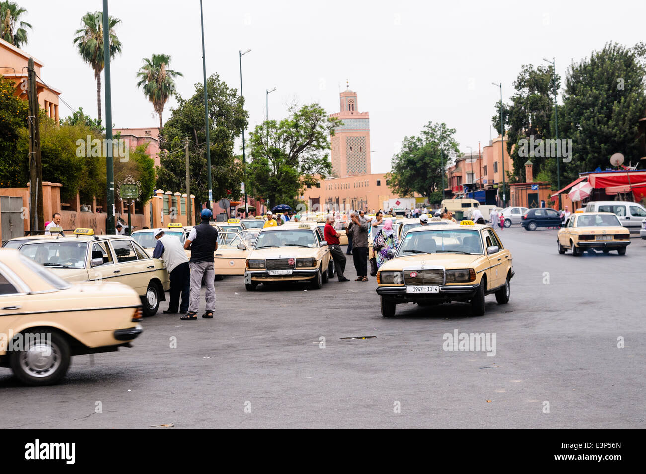 Old Mercedes taxis at their taxi rank along a street in Marrakech, Morocco Stock Photo