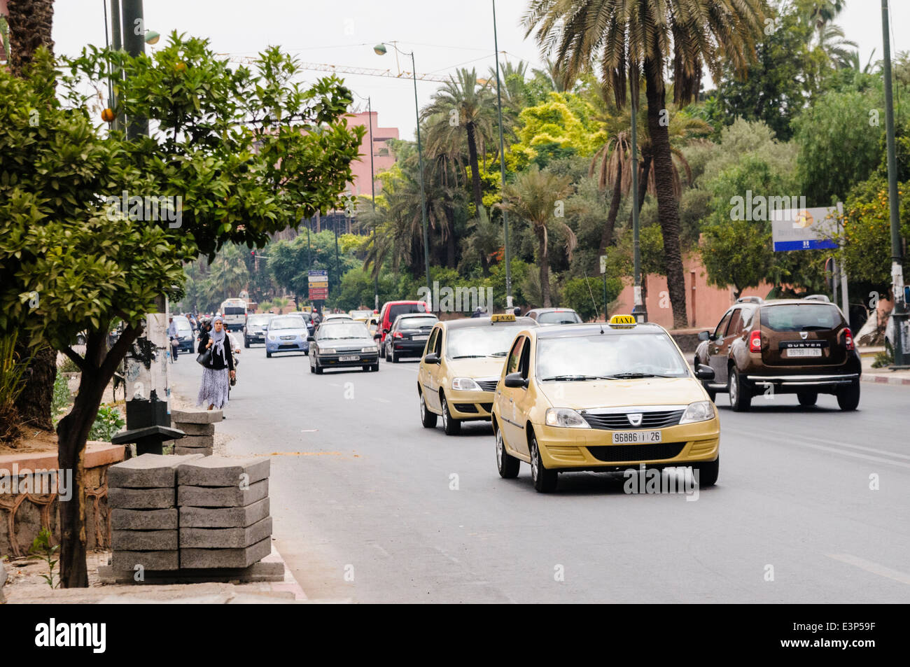 Newer, cleaner Dacia beige taxis on the roads around Marrakech, Morocco.  Traditional petit taxis in Morocco tend to be very old Mercedes Benz cars. Stock Photo