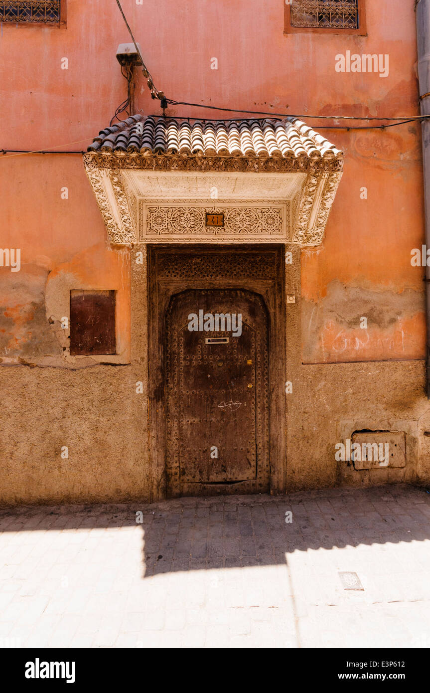 Wooden door of a pink building in the Medina of Marrakech, Morocco Stock Photo