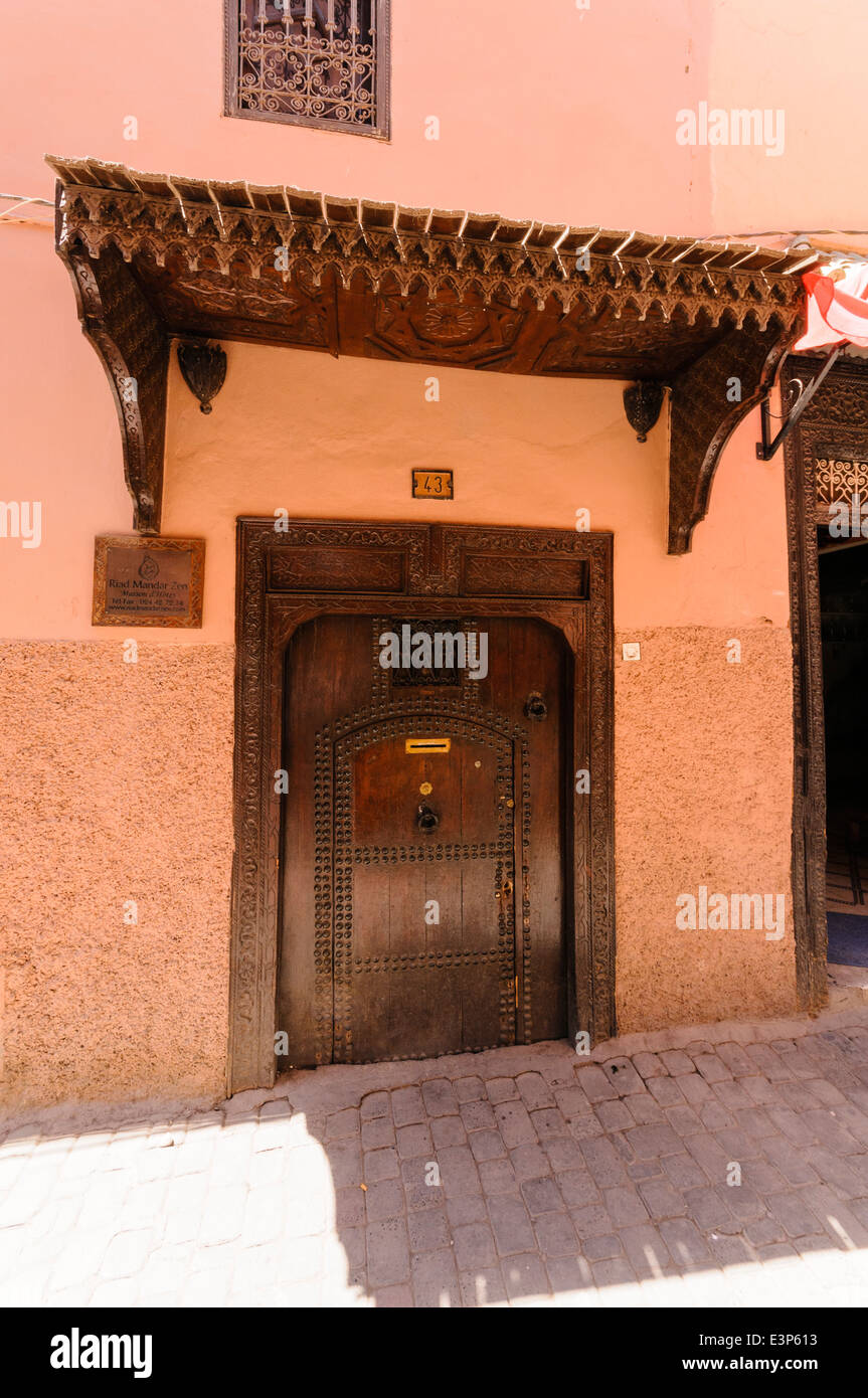 Wooden door of a pink building in the Medina of Marrakech, Morocco Stock Photo