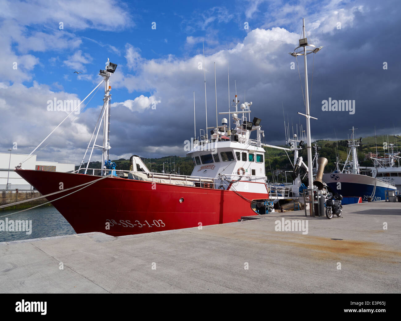 Fishing vessel in Getaria, Gipuzkoa, Basque Country Spain. A fishing trawler prepares to leave the busy commercial fishing port. Stock Photo