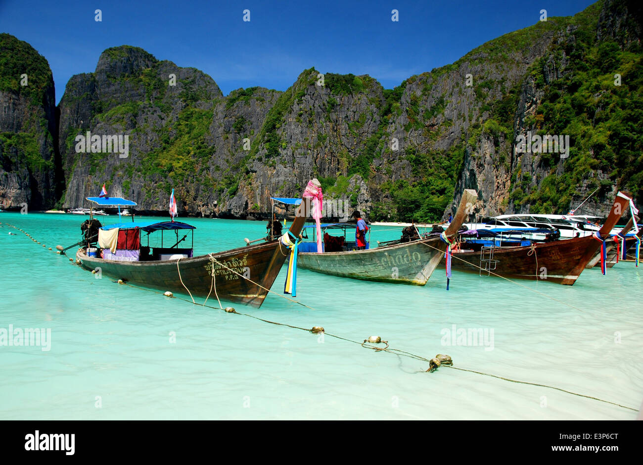 PHUKET, THAILAND: Long boats docked near the pristine beach at famed Maya Bay on Phi Phi Island  * Stock Photo