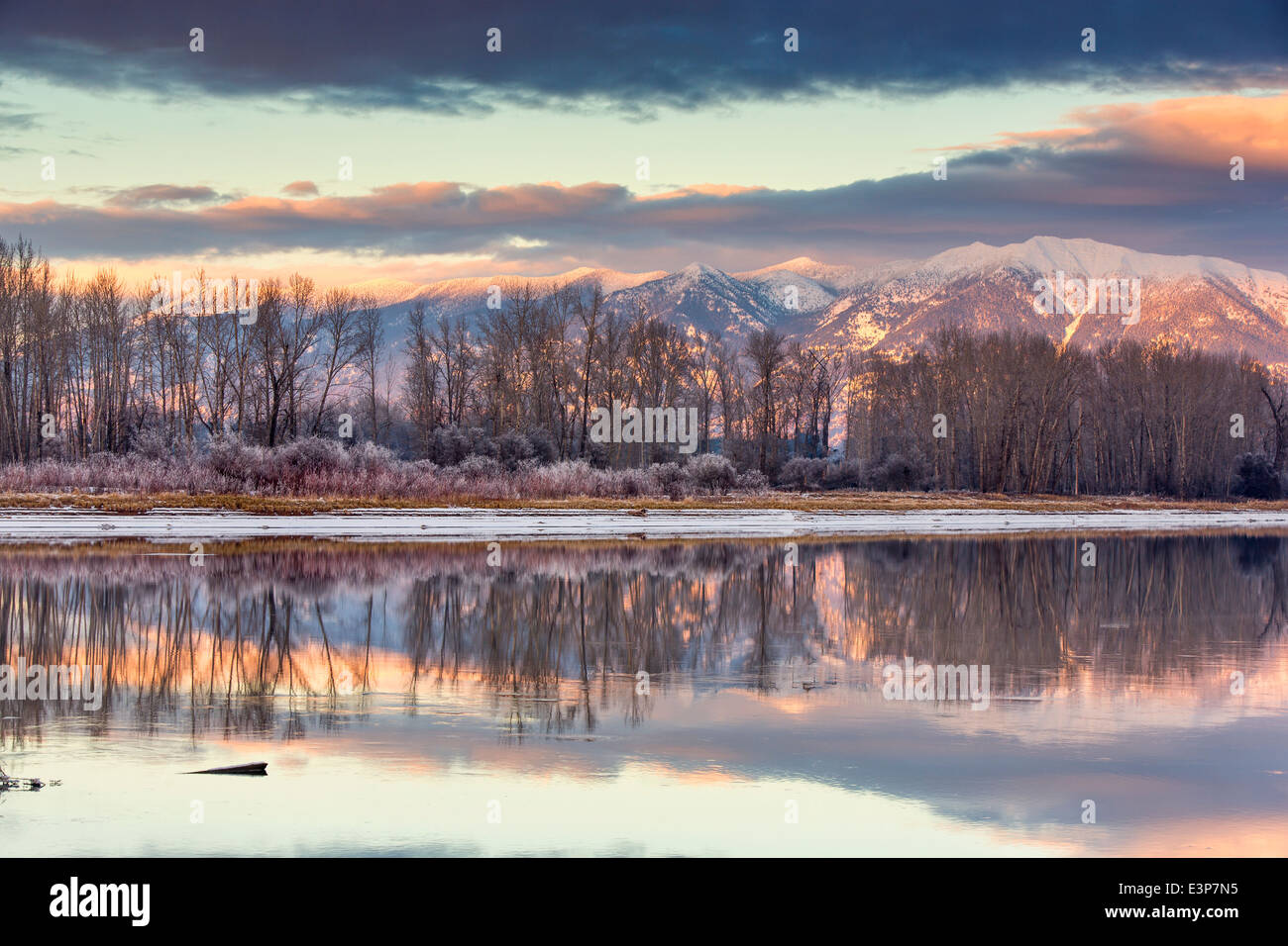 Swan Mountains reflect into the Flathead River at sunset near Kalispell, Montana, USA Stock