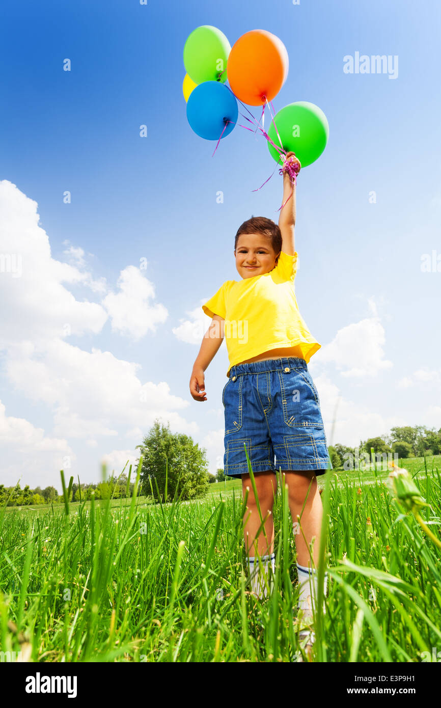 Funny small boy with colorful balloons Stock Photo Alamy