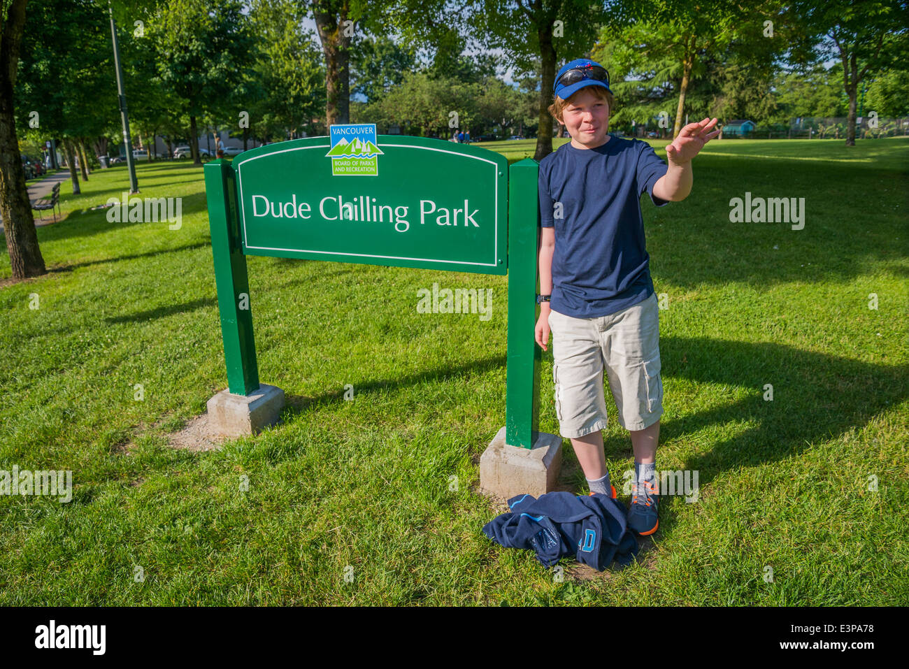 Pre teen by Dude Chilling Park sign, Strathcona, Vancouver, British Columbia, Canada Stock Photo
