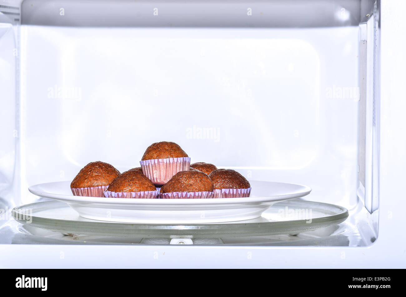 baking muffins in oven Stock Photo Alamy