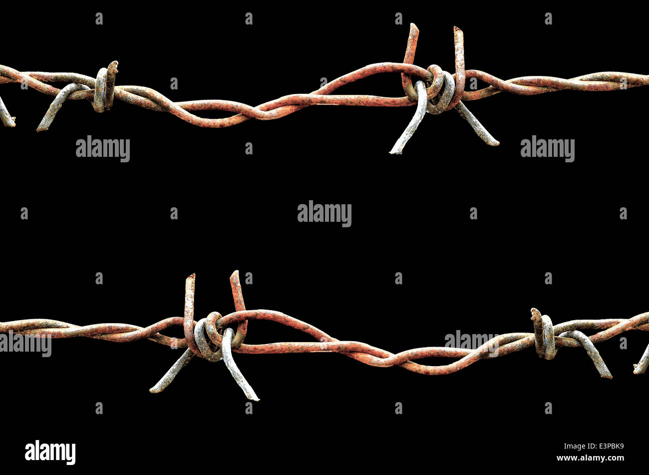 Rusty barbed wire on black background Stock Photo