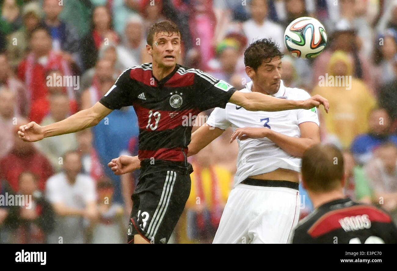 Recife, Brazil. 26th June, 2014. Germany's Thomas Muller (L) vies with Omar Gonzalez of the U.S. during a Group G match between the U.S. and Germany of 2014 FIFA World Cup at the Arena Pernambuco Stadium in Recife, Brazil, on June 26, 2014. Credit:  Guo Yong/Xinhua/Alamy Live News Stock Photo