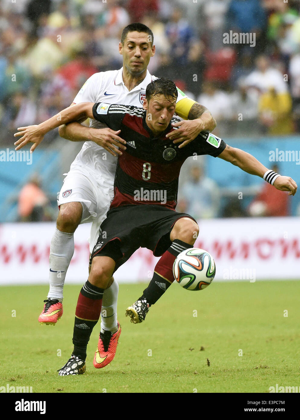 Recife, Brazil. 26th June, 2014. Clint Dempsey of the U.S. (L) vies with Germany's Mesut Ozil during a Group G match between the U.S. and Germany of 2014 FIFA World Cup at the Arena Pernambuco Stadium in Recife, Brazil, on June 26, 2014. Credit:  Lui Siu Wai/Xinhua/Alamy Live News Stock Photo