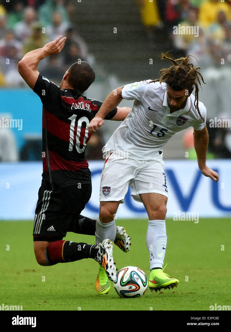 Recife, Brazil. 26th June, 2014. Germany's Lukas Podolski (L) vies with Kyle Beckerman of the U.S. during a Group G match between the U.S. and Germany of 2014 FIFA World Cup at the Arena Pernambuco Stadium in Recife, Brazil, on June 26, 2014. Credit:  Guo Yong/Xinhua/Alamy Live News Stock Photo