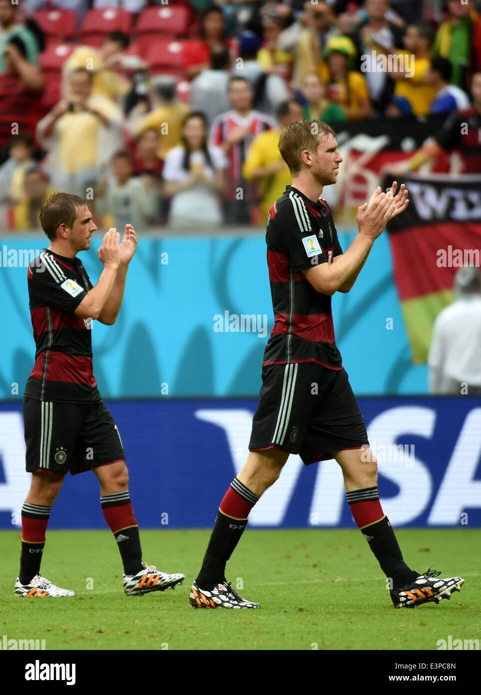 Recife, Brazil. 26th June, 2014. Germany's Philipp Lahm (L) and Per Mertesacker celebrate the victory and their entrance to Rround of 16 after a Group G match between the U.S. and Germany of 2014 FIFA World Cup at the Arena Pernambuco Stadium in Recife, Brazil, on June 26, 2014. Germany won 1-0 over the U.S. on Thursday. Germany and the U.S. enter Round of 16 from Group G. Credit:  Guo Yong/Xinhua/Alamy Live News Stock Photo