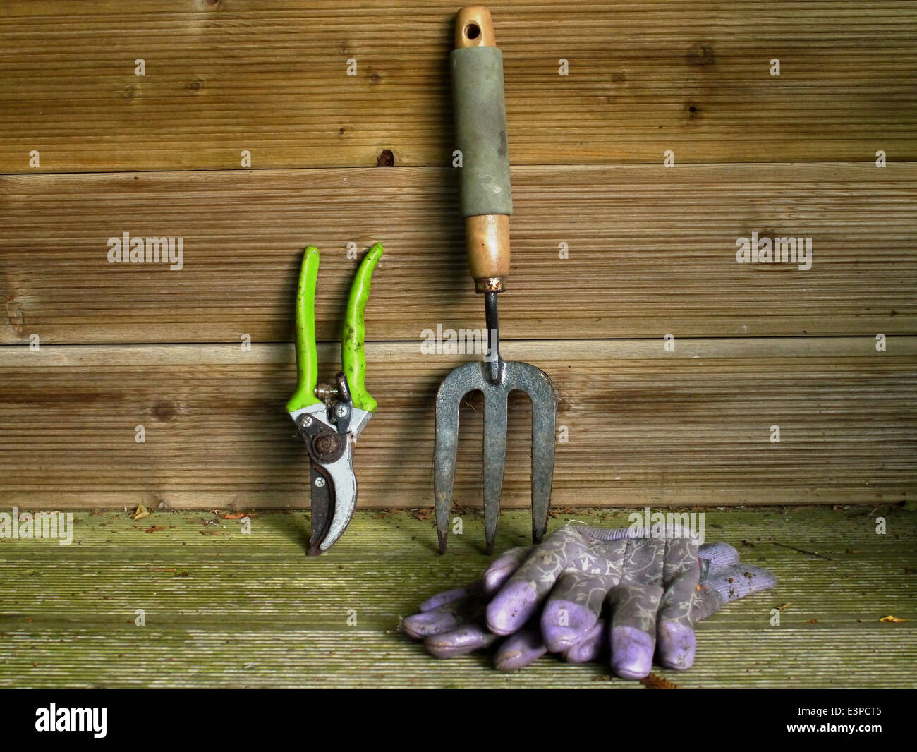 Garden seat with tools and gloves Stock Photo