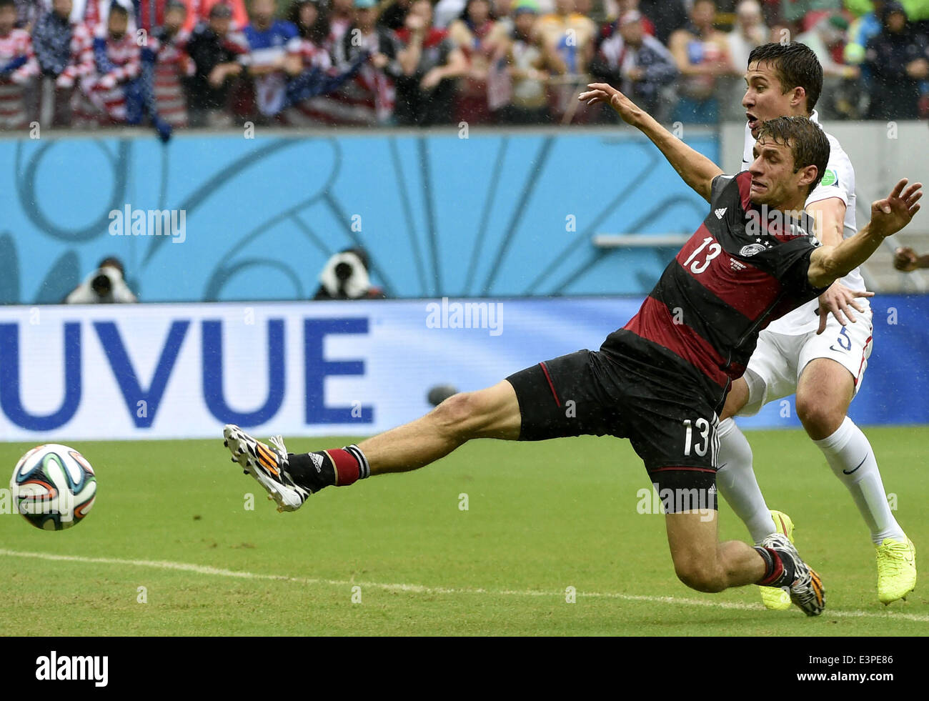 Recife, Brazil. 26th June, 2014. Germany's Thomas Muller (L) vies with Matt Besler of the U.S. during a Group G match between the U.S. and Germany of 2014 FIFA World Cup at the Arena Pernambuco Stadium in Recife, Brazil, on June 26, 2014. Credit:  Lui Siu Wai/Xinhua/Alamy Live News Stock Photo