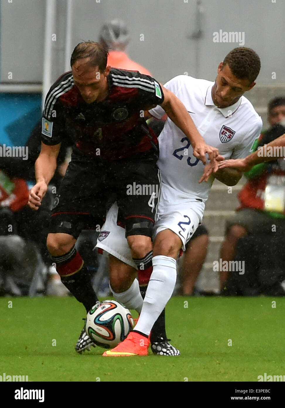 Recife, Brazil. 26th June, 2014. Germany's Benedikt Howedes (L) vies with Fabian Johnson of the U.S. during a Group G match between the U.S. and Germany of 2014 FIFA World Cup at the Arena Pernambuco Stadium in Recife, Brazil, on June 26, 2014. Credit:  Guo Yong/Xinhua/Alamy Live News Stock Photo