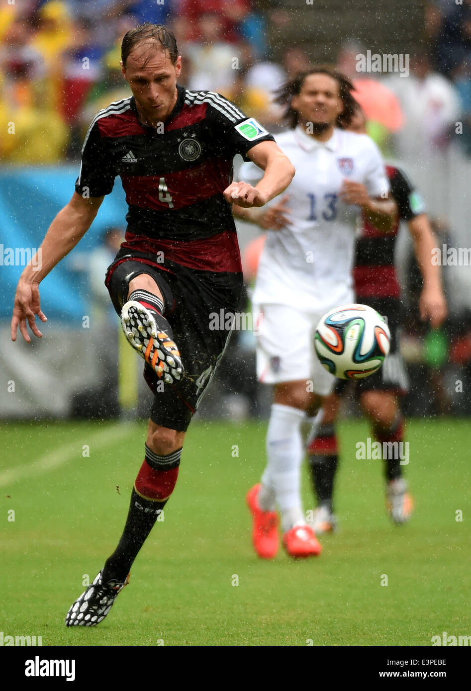 Recife, Brazil. 26th June, 2014. Germany's Benedikt Howedes (front) passes the ball during a Group G match between the U.S. and Germany of 2014 FIFA World Cup at the Arena Pernambuco Stadium in Recife, Brazil, on June 26, 2014. Credit:  Guo Yong/Xinhua/Alamy Live News Stock Photo