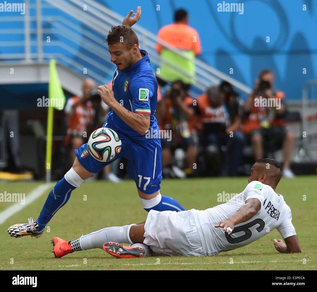 Natal, Brazil. 24th June, 2014. Italy's Ciro Immobile vies with Uruguay's Alvaro Pereira during a Group D match between Italy and Uruguay of 2014 FIFA World Cup at the Estadio das Dunas Stadium in Natal, Brazil, June 24, 2014. © Guo Yong/Xinhua/Alamy Live News Stock Photo
