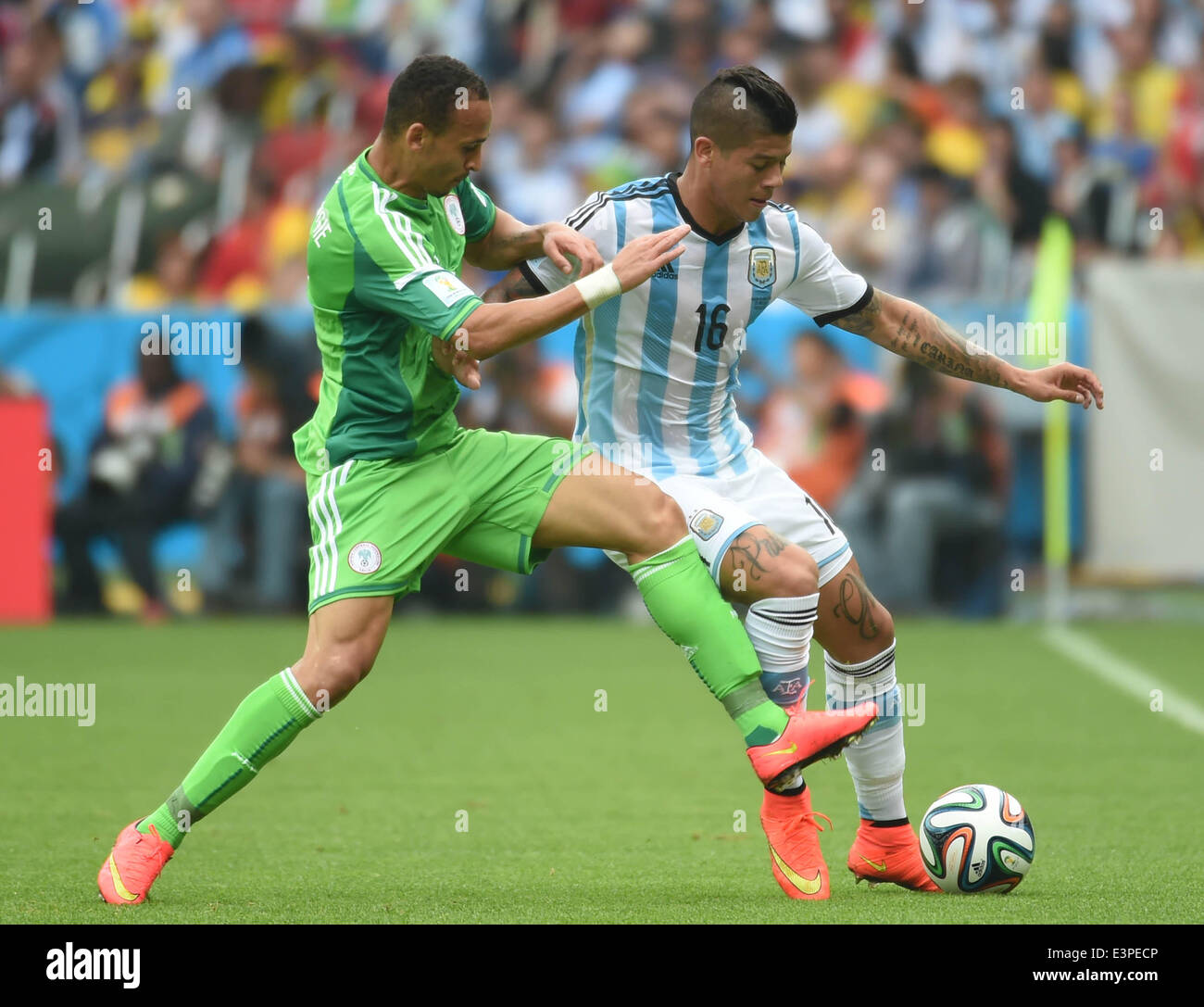 Porto Alegre, Brazil. 25th June, 2014. Argentina's Marcos Rojo (R) vies with Nigeria's Peter Osaze Odemwingie during a Group F match between Nigeria and Argentina of 2014 FIFA World Cup at the Estadio Beira-Rio Stadium in Porto Alegre, Brazil, on June 25, 2014. © Li Ga/Xinhua/Alamy Live News Stock Photo