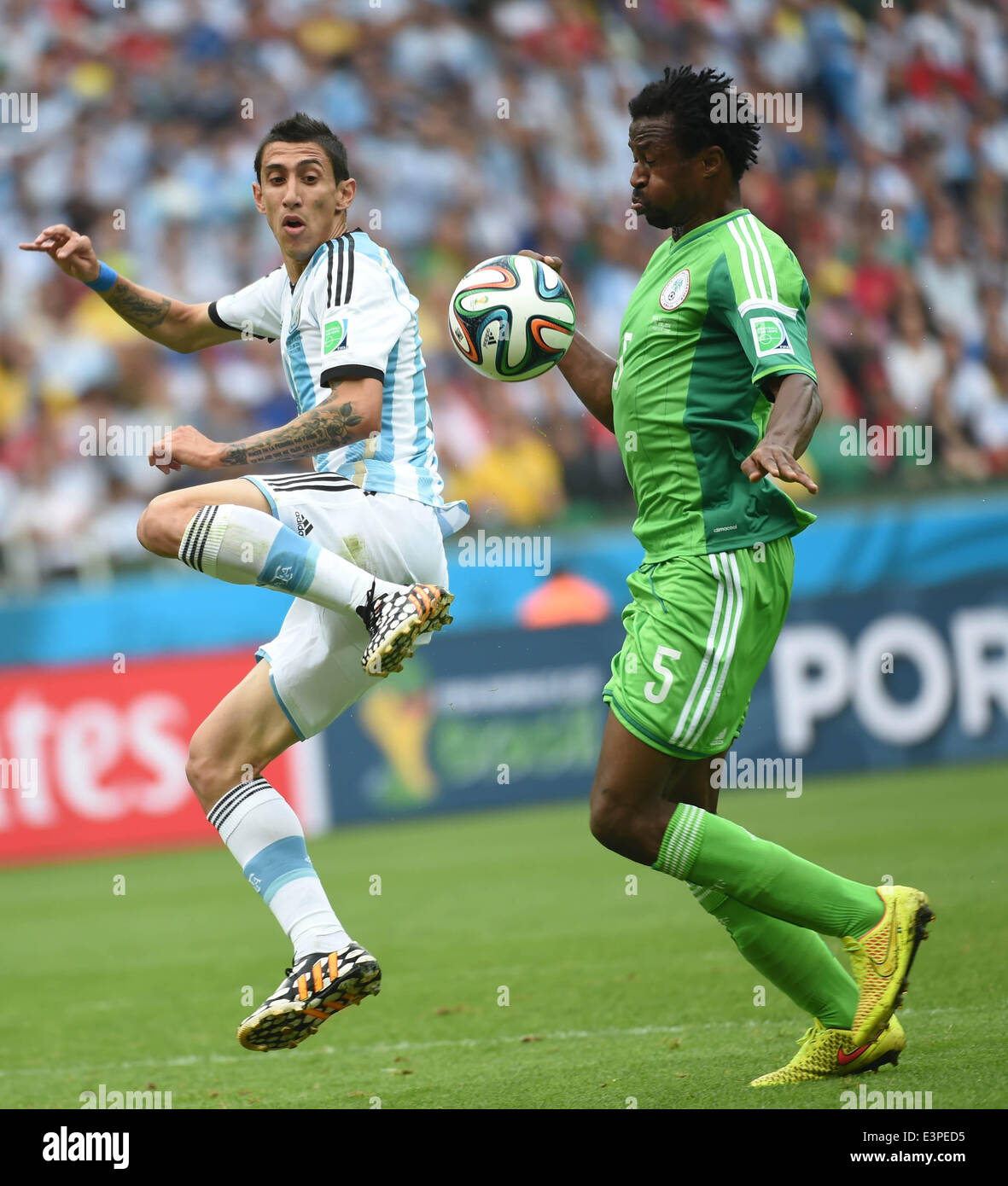 Porto Alegre, Brazil. 25th June, 2014. Argentina's Angel Di Maria (L) vies with Nigeria's Efe Ambrose during a Group F match between Nigeria and Argentina of 2014 FIFA World Cup at the Estadio Beira-Rio Stadium in Porto Alegre, Brazil, on June 25, 2014. © Li Ga/Xinhua/Alamy Live News Stock Photo