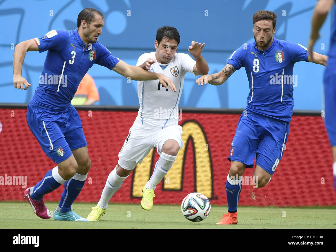 Natal, Brazil. 24th June, 2014. Uruguay's Nicolas Lodeiro (C) vies for the ball during a Group D match between Italy and Uruguay of 2014 FIFA World Cup at the Estadio das Dunas Stadium in Natal, Brazil, June 24, 2014. © Guo Yong/Xinhua/Alamy Live News Stock Photo