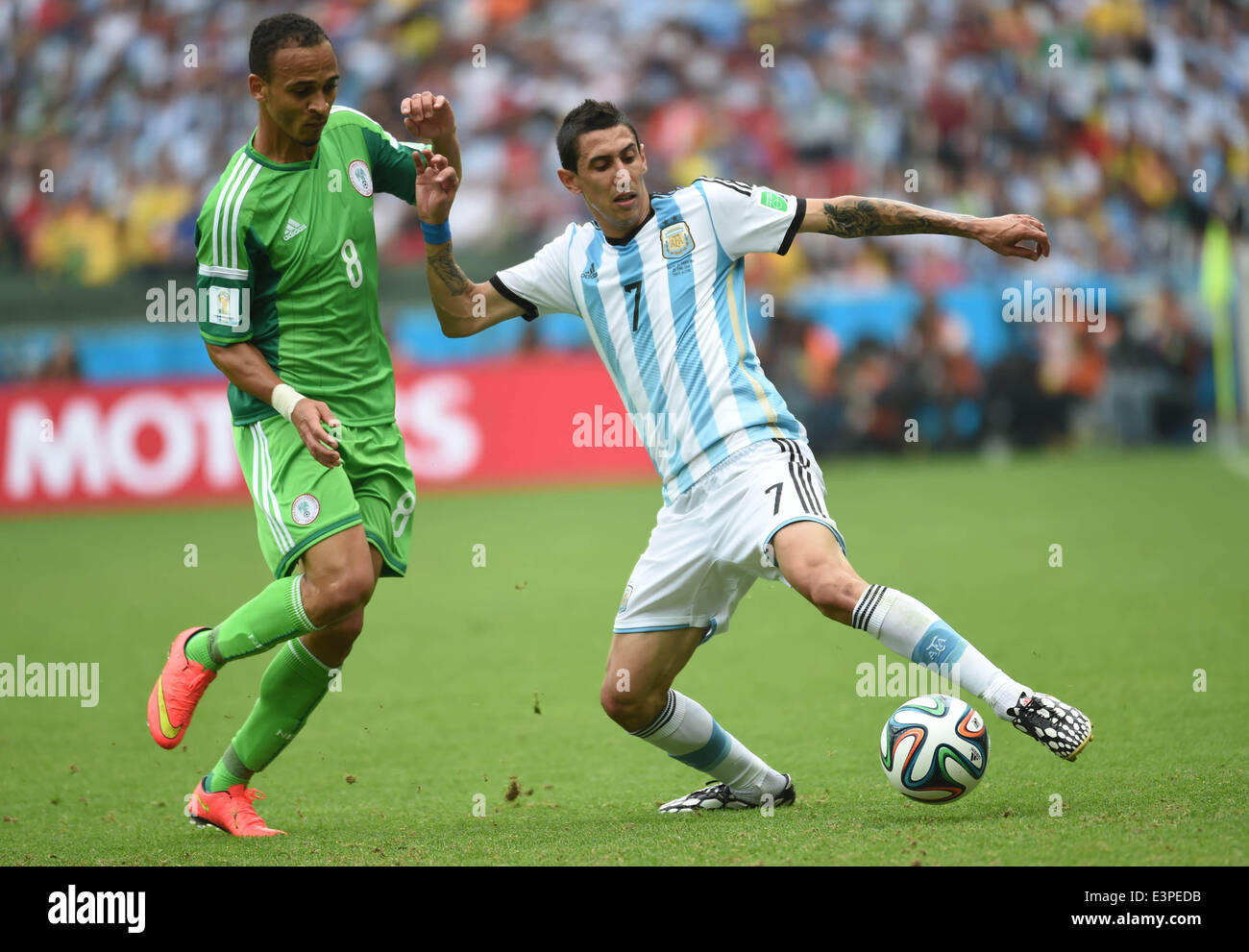 Porto Alegre, Brazil. 25th June, 2014. Argentina's Angel Di Maria (R) vies with Nigeria's Peter Osaze Odemwingie during a Group F match between Nigeria and Argentina of 2014 FIFA World Cup at the Estadio Beira-Rio Stadium in Porto Alegre, Brazil, on June 25, 2014. © Li Ga/Xinhua/Alamy Live News Stock Photo