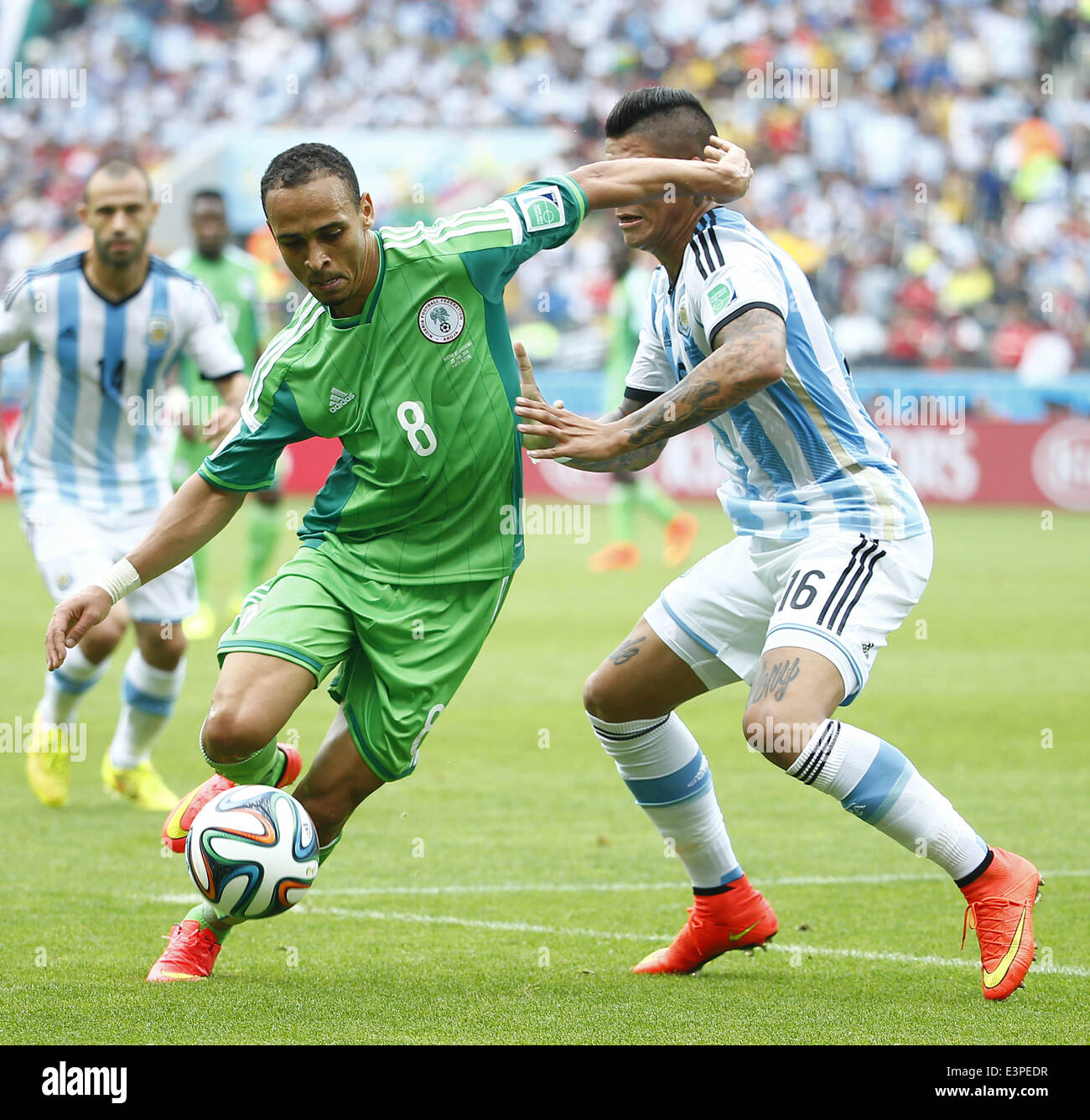 Porto Alegre, Brazil. 25th June, 2014. Nigeria's Peter Osaze Odemwingie (L, front) vies with Argentina's Marcos Rojo during a Group F match between Nigeria and Argentina of 2014 FIFA World Cup at the Estadio Beira-Rio Stadium in Porto Alegre, Brazil, on June 25, 2014. © Chen Jianli/Xinhua/Alamy Live News Stock Photo