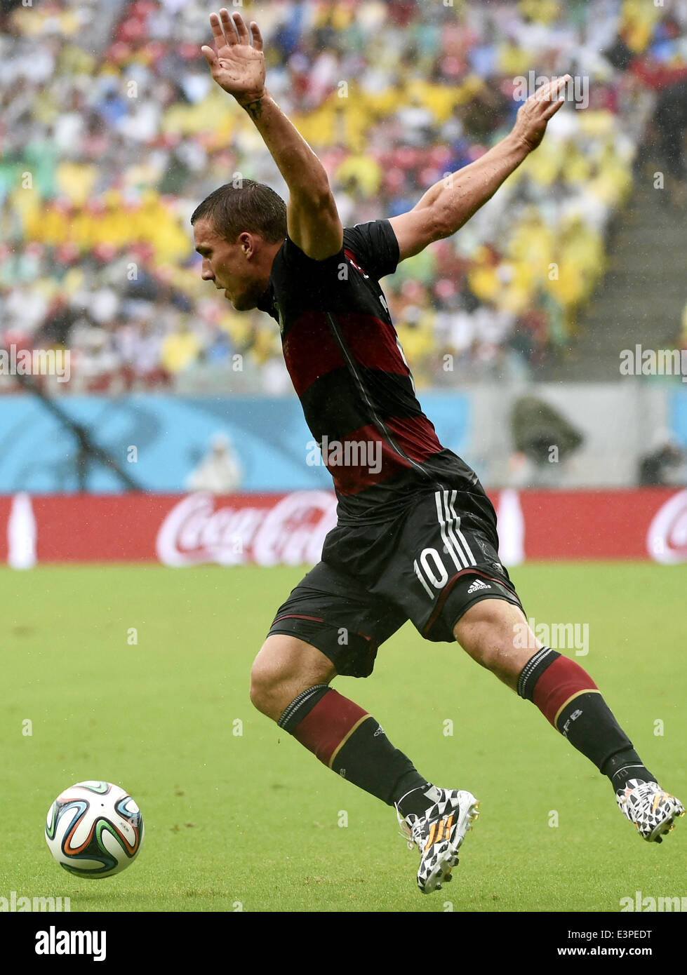 Recife, Brazil. 26th June, 2014. Germany's Lukas Podolski controls the ball during a Group G match between the U.S. and Germany of 2014 FIFA World Cup at the Arena Pernambuco Stadium in Recife, Brazil, on June 26, 2014. Credit:  Lui Siu Wai/Xinhua/Alamy Live News Stock Photo