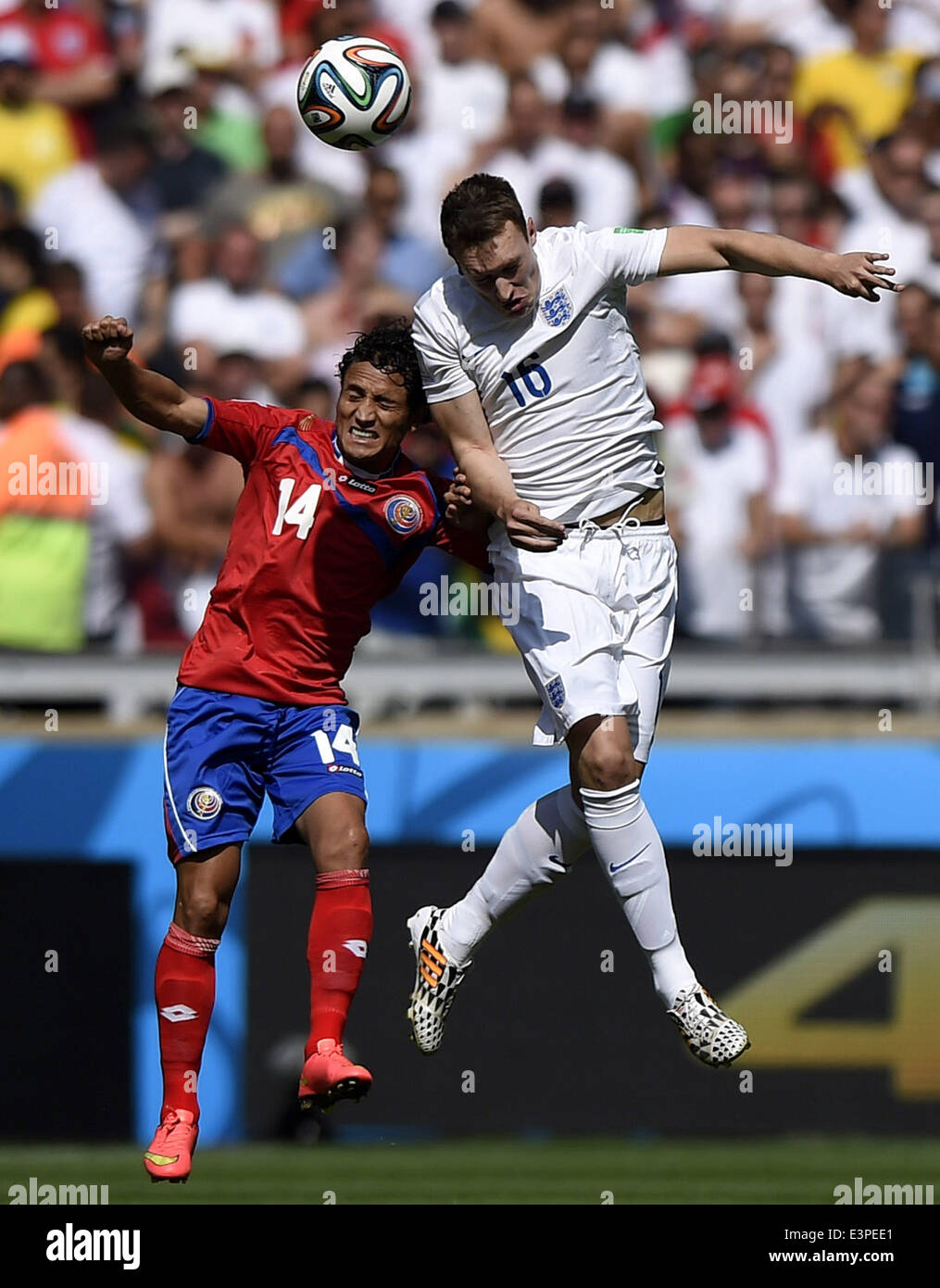 Belo Horizonte, Brazil. 24th June, 2014. Costa Rica's Randall Brenes (L) competes for a header with England's Phil Jones during a Group D match between Costa Rica and England of 2014 FIFA World Cup at the Estadio Mineirao Stadium in Belo Horizonte, Brazil, on June 24, 2014. © Qi Heng/Xinhua/Alamy Live News Stock Photo
