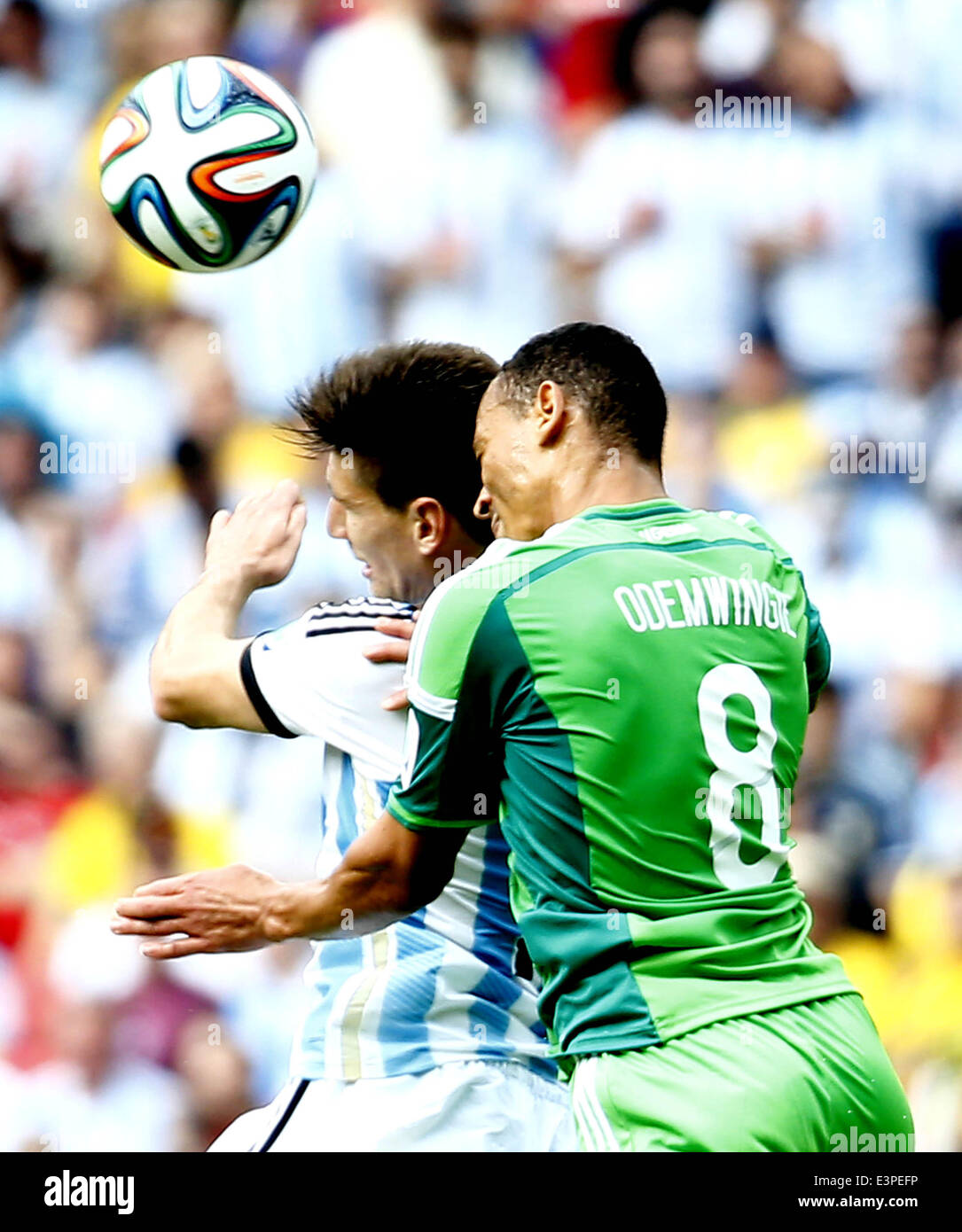 Porto Alegre, Brazil. 25th June, 2014. Nigeria's Peter Osaze Odemwingie (R) competes for a header during a Group F match between Nigeria and Argentina of 2014 FIFA World Cup at the Estadio Beira-Rio Stadium in Porto Alegre, Brazil, on June 25, 2014. © Chen Jianli/Xinhua/Alamy Live News Stock Photo
