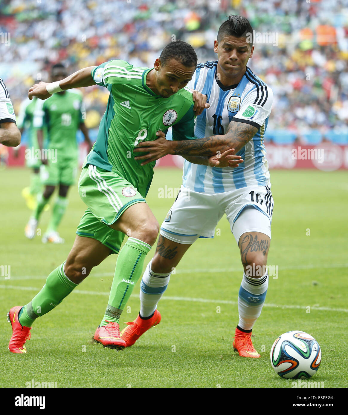 Porto Alegre, Brazil. 25th June, 2014. Nigeria's Peter Osaze Odemwingie (L) vies with Argentina's Marcos Rojo during a Group F match between Nigeria and Argentina of 2014 FIFA World Cup at the Estadio Beira-Rio Stadium in Porto Alegre, Brazil, on June 25, 2014. © Chen Jianli/Xinhua/Alamy Live News Stock Photo