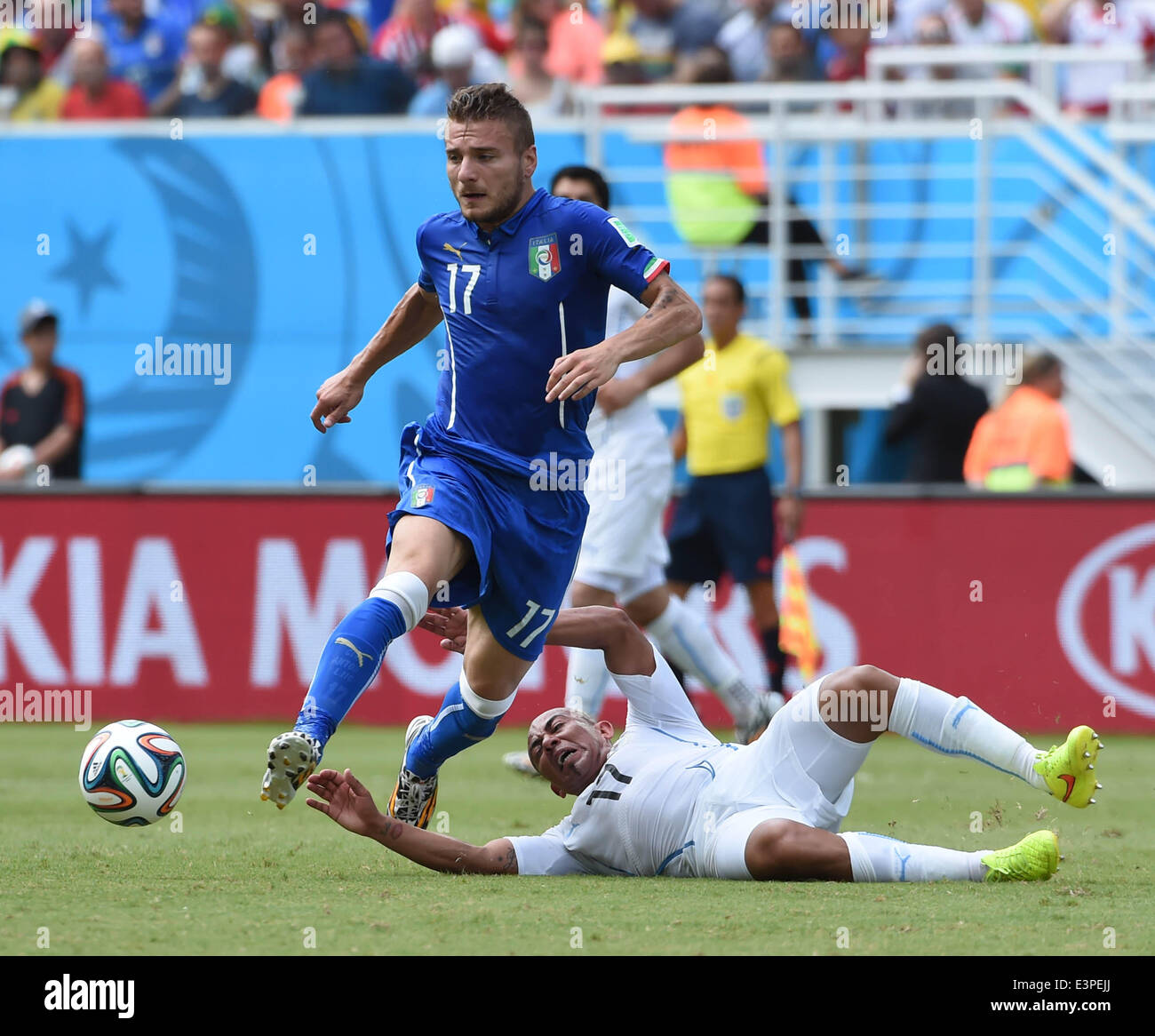 Natal, Brazil. 24th June, 2014. Italy's Ciro Immobile vies for the ball with Uruguay's Egidio Arevalo Rios during a Group D match between Italy and Uruguay of 2014 FIFA World Cup at the Estadio das Dunas Stadium in Natal, Brazil, June 24, 2014. © Guo Yong/Xinhua/Alamy Live News Stock Photo