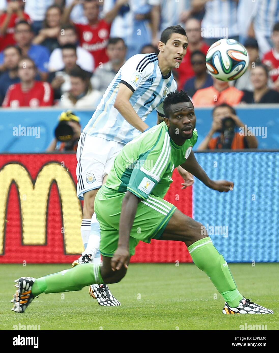 Porto Alegre, Brazil. 25th June, 2014. Argentina's Angel Di Maria (back) vies with Nigeria's Joseph Yobo during a Group F match between Nigeria and Argentina of 2014 FIFA World Cup at the Estadio Beira-Rio Stadium in Porto Alegre, Brazil, on June 25, 2014. © Chen Jianli/Xinhua/Alamy Live News Stock Photo
