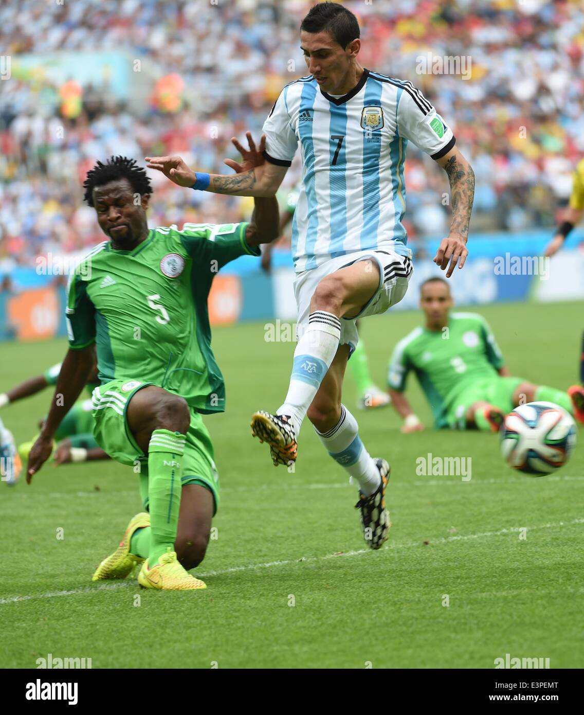 Porto Alegre, Brazil. 25th June, 2014. Argentina's Angel Di Maria (R, front) vies with Nigeria's Efe Ambrose during a Group F match between Nigeria and Argentina of 2014 FIFA World Cup at the Estadio Beira-Rio Stadium in Porto Alegre, Brazil, on June 25, 2014. © Li Ga/Xinhua/Alamy Live News Stock Photo