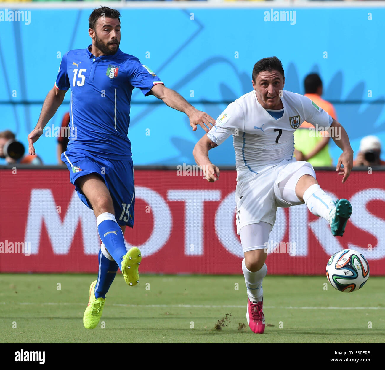 Natal, Brazil. 24th June, 2014. Italy's Andrea Barzagli vies with Uruguay's Cristian Rodriguez during a Group D match between Italy and Uruguay of 2014 FIFA World Cup at the Estadio das Dunas Stadium in Natal, Brazil, June 24, 2014. © Guo Yong/Xinhua/Alamy Live News Stock Photo