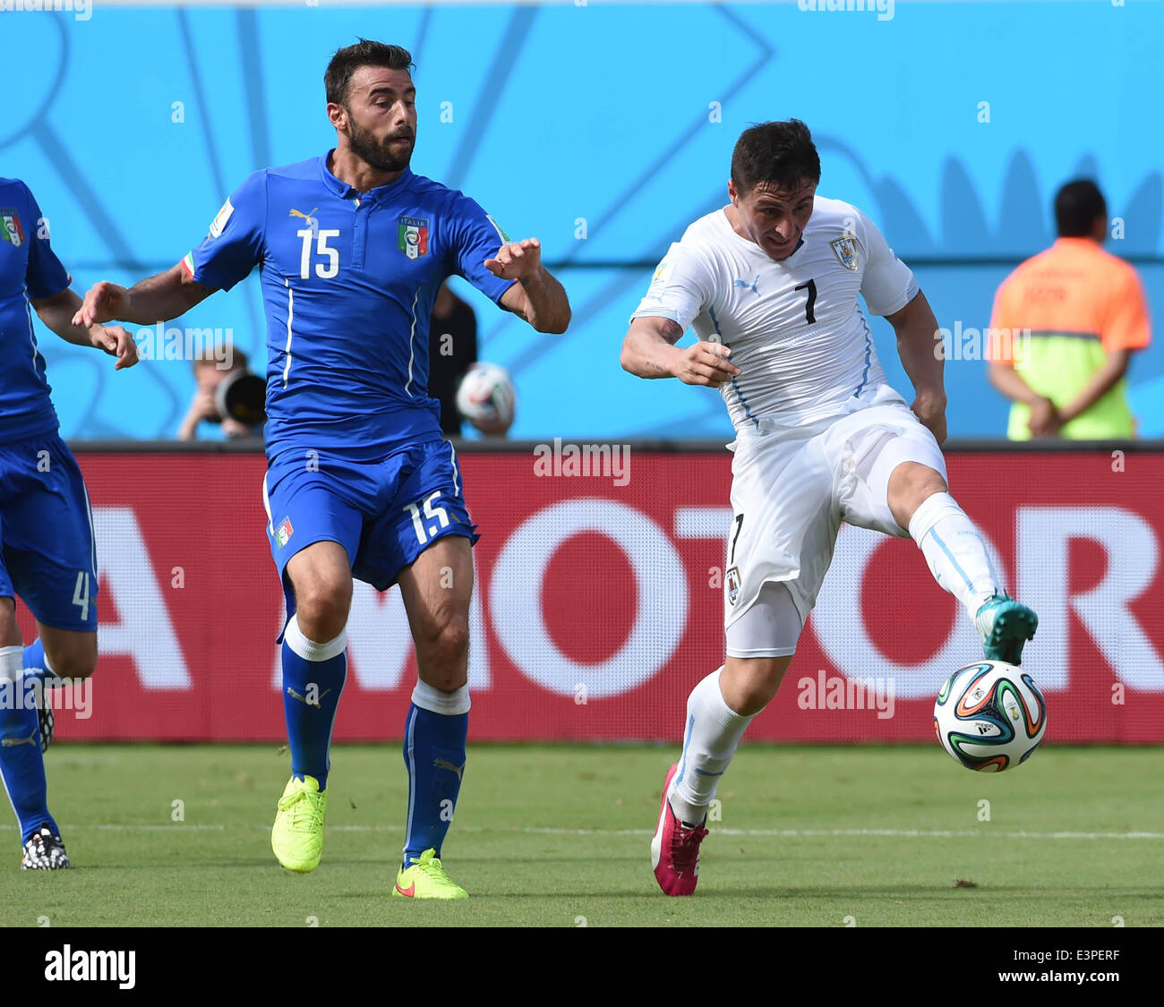 Natal, Brazil. 24th June, 2014. Italy's Andrea Barzagli vies with Uruguay's Cristian Rodriguez during a Group D match between Italy and Uruguay of 2014 FIFA World Cup at the Estadio das Dunas Stadium in Natal, Brazil, June 24, 2014. © Guo Yong/Xinhua/Alamy Live News Stock Photo
