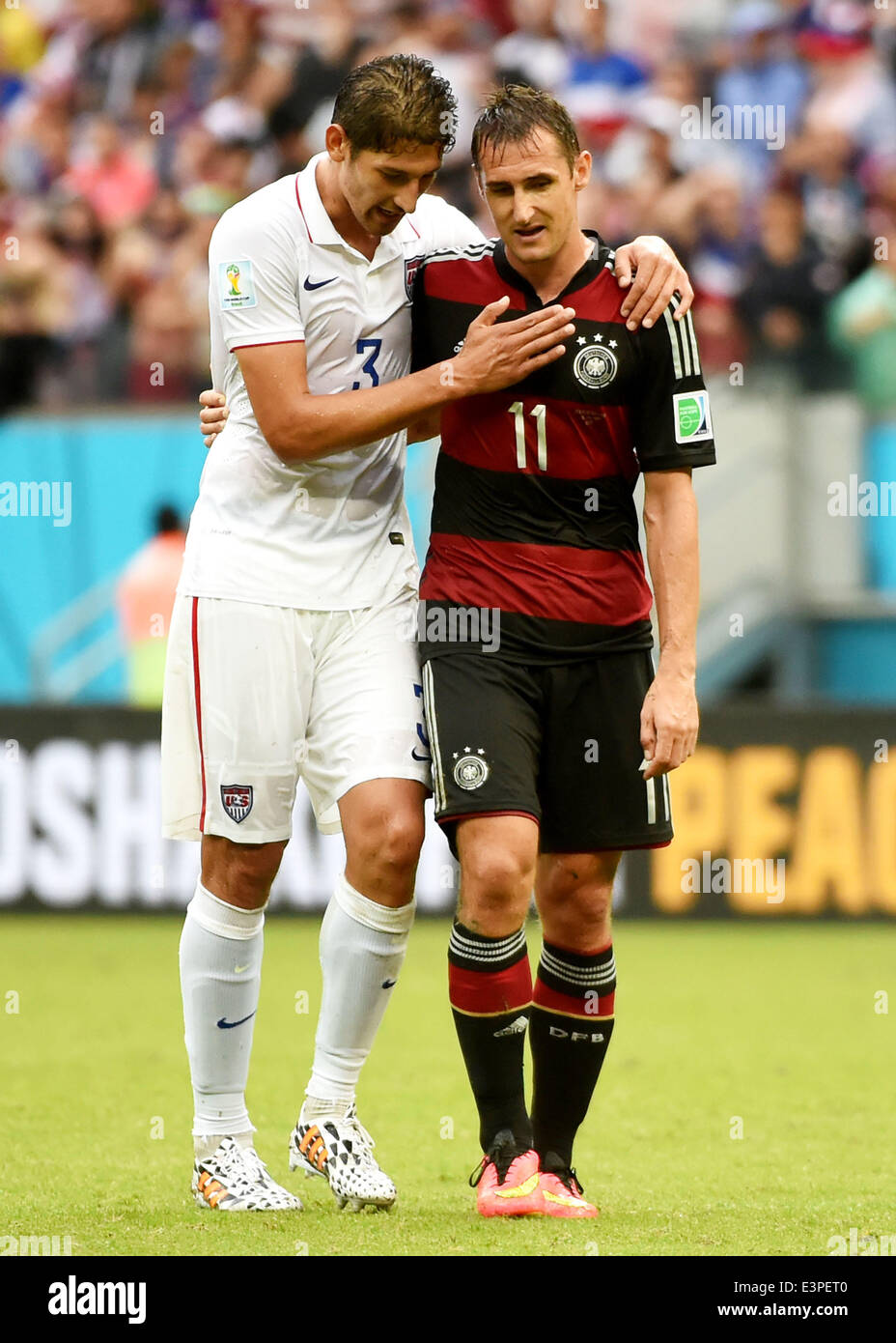 Recife, Brazil. 26th June, 2014. Omar Gonzalez of the U.S. (L) talks with Germany's Miroslav Klose after a Group G match between the U.S. and Germany of 2014 FIFA World Cup at the Arena Pernambuco Stadium in Recife, Brazil, on June 26, 2014. Germany won 1-0 over the U.S. on Thursday. Germany and the U.S. enter Round of 16 from Group G. Credit:  Guo Yong/Xinhua/Alamy Live News Stock Photo