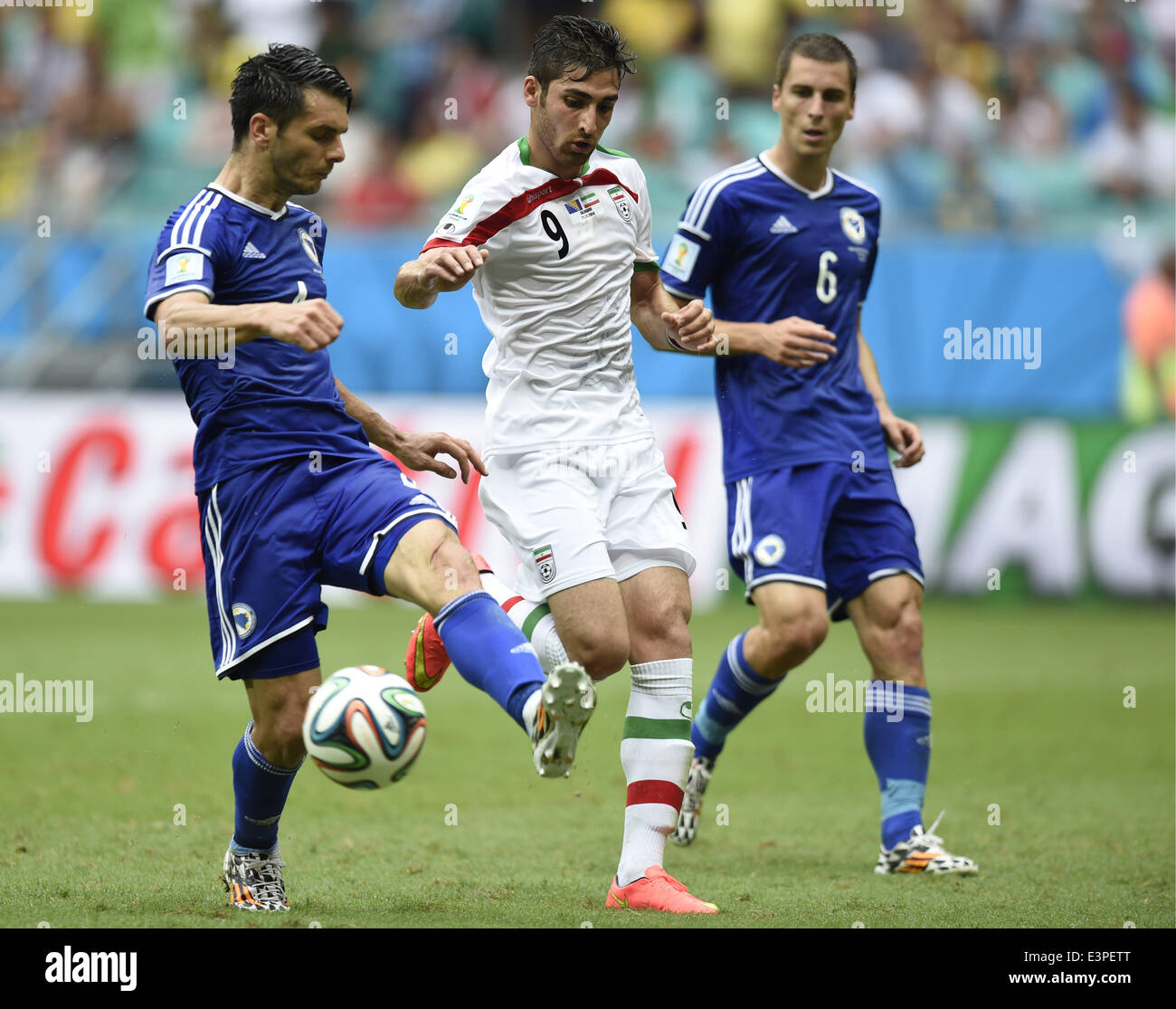 Salvador, Brazil. 24th June, 2014. Iran's Alireza Jahanbakhsh (C) vies for the ball during a Group F match between Bosnia And Herzegovina and Iran of 2014 FIFA World Cup at the Arena Fonte Nova Stadium in Salvador, Brazil, June 24, 2014. Bosnia And Herzegovina won 3-1 over Iran on Wednesday. © Yang Lei/Xinhua/Alamy Live News Stock Photo