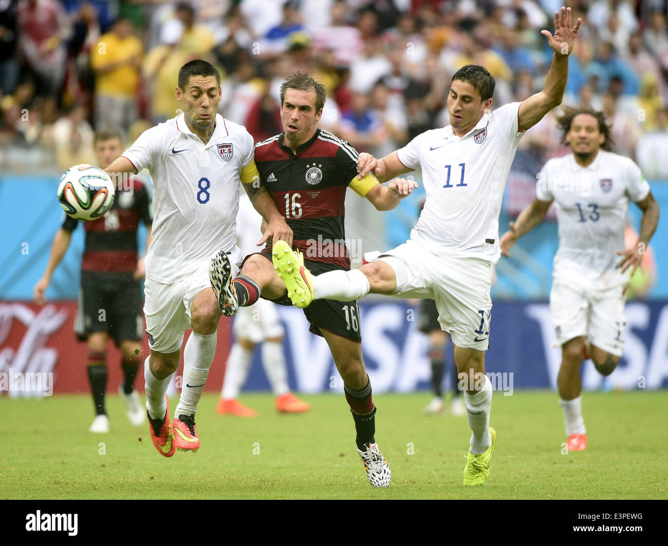 Recife, Brazil. 26th June, 2014. Germany's Philipp Lahm (C, front) vies with Clint Dempsey (L, front) and Alejandro Bedoya of the U.S. during a Group G match between the U.S. and Germany of 2014 FIFA World Cup at the Arena Pernambuco Stadium in Recife, Brazil, on June 26, 2014. Germany won 1-0 over the U.S. on Thursday. Germany and the U.S. enter Round of 16 from Group G. Credit:  Lui Siu Wai/Xinhua/Alamy Live News Stock Photo