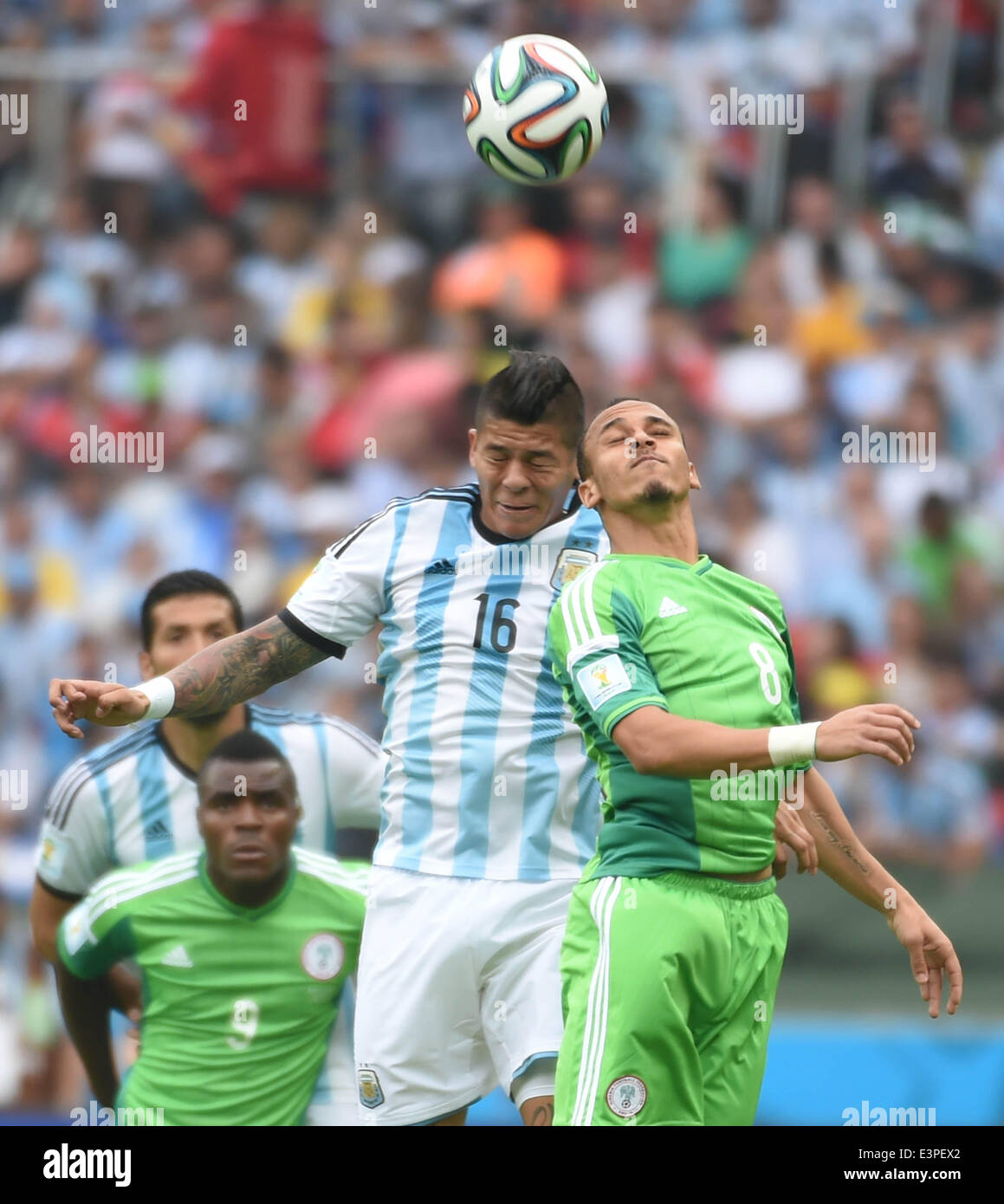 Porto Alegre, Brazil. 25th June, 2014. Argentina's Marcos Rojo (2nd R) competes for a header with Nigeria's Peter Osaze Odemwingie (1st R)during a Group F match between Nigeria and Argentina of 2014 FIFA World Cup at the Estadio Beira-Rio Stadium in Porto Alegre, Brazil, on June 25, 2014. Argentina won 3-2 over Nigeria on Wednesday. © Li Ga/Xinhua/Alamy Live News Stock Photo