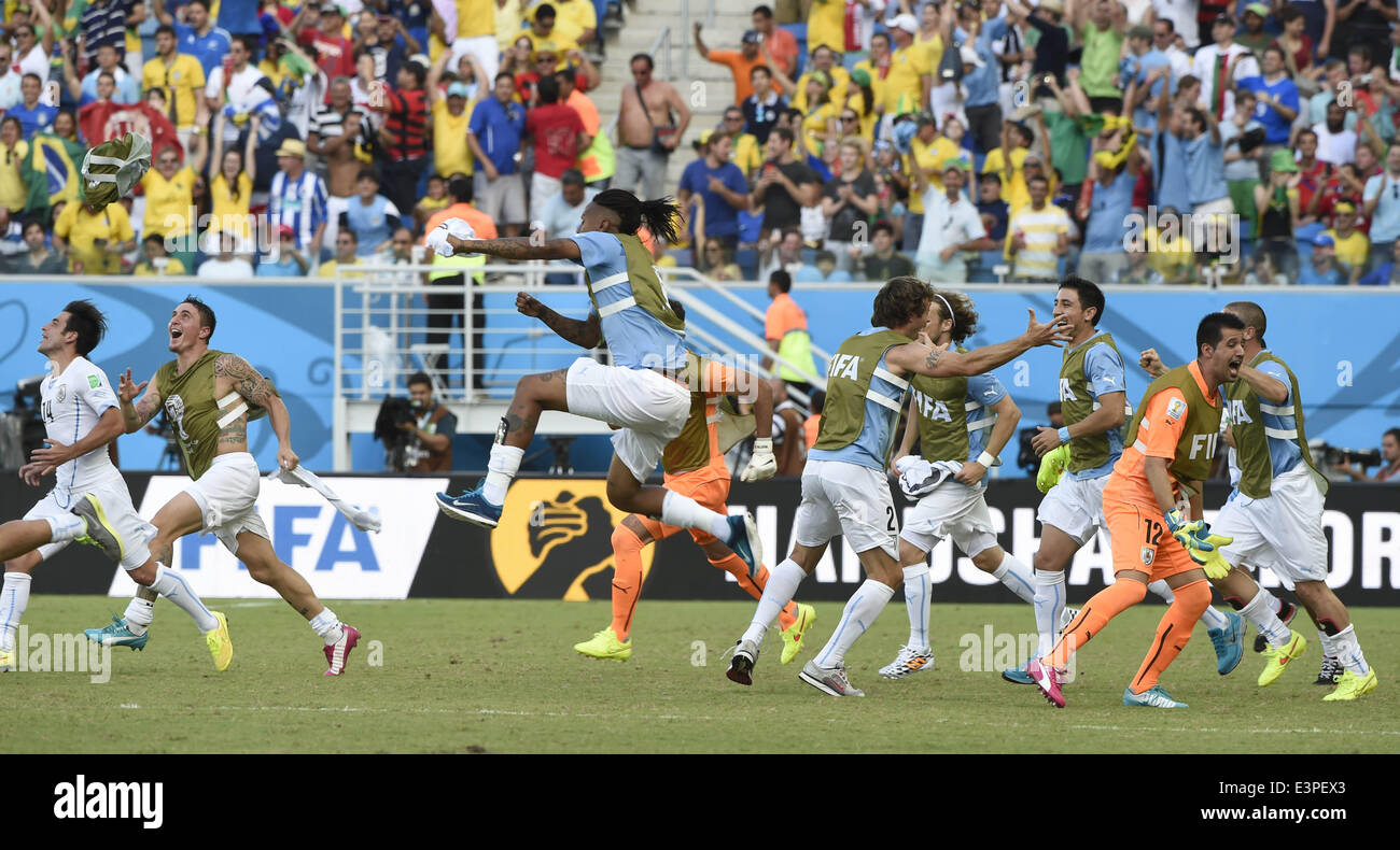 Natal, Brazil. 24th June, 2014. Uruguay's players celebrate the victory after a Group D match between Italy and Uruguay of 2014 FIFA World Cup at the Estadio das Dunas Stadium in Natal, Brazil, June 24, 2014. Uruguay won 1-0 over Italy on Tuesday. © Guo Yong/Xinhua/Alamy Live News Stock Photo