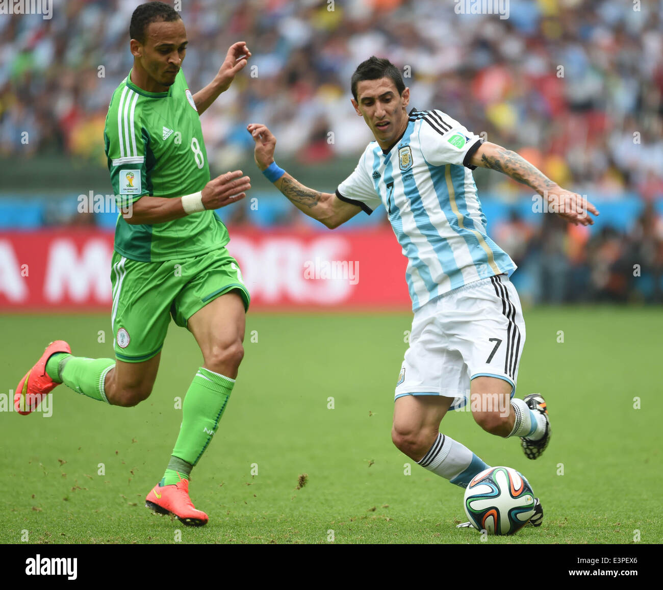 Porto Alegre, Brazil. 25th June, 2014. Argentina's Angel Di Maria (R) vies with Nigeria's Peter Osaze Odemwingie during a Group F match between Nigeria and Argentina of 2014 FIFA World Cup at the Estadio Beira-Rio Stadium in Porto Alegre, Brazil, on June 25, 2014. Argentina won 3-2 over Nigeria on Wednesday. © Li Ga/Xinhua/Alamy Live News Stock Photo