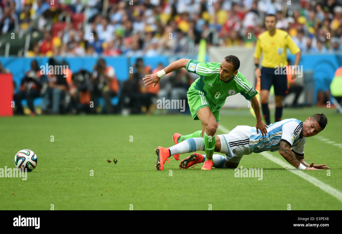 Porto Alegre, Brazil. 25th June, 2014. Nigeria's Peter Osaze Odemwingie (L) competes with Argentina's Marcos Rojo during a Group F match between Nigeria and Argentina of 2014 FIFA World Cup at the Estadio Beira-Rio Stadium in Porto Alegre, Brazil, on June 25, 2014. Argentina won 3-2 over Nigeria on Wednesday. © Li Ga/Xinhua/Alamy Live News Stock Photo