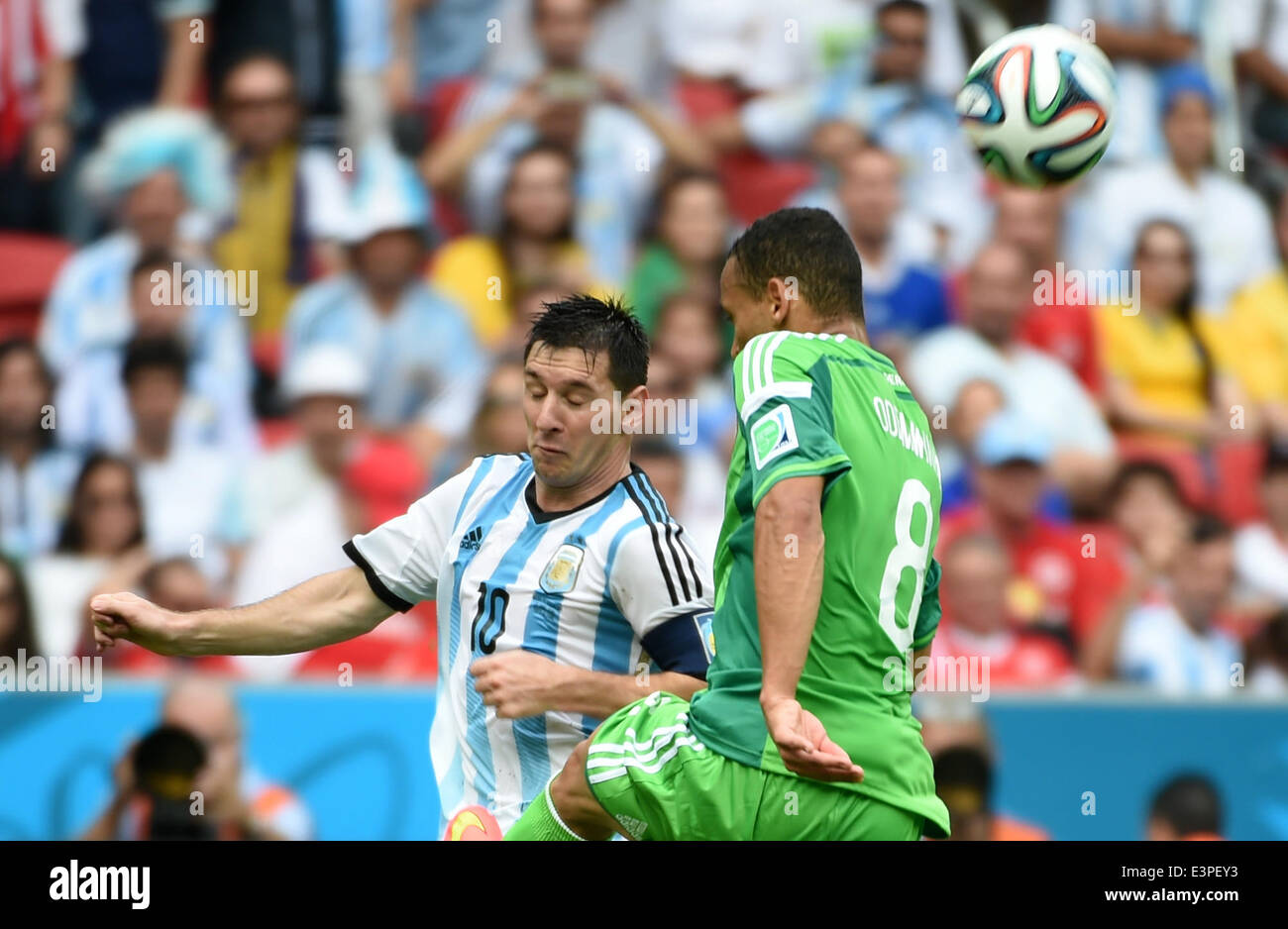 Porto Alegre, Brazil. 25th June, 2014. Argentina's Lionel Messi (L) competes with Nigeria's Peter Osaze Odemwingie during a Group F match between Nigeria and Argentina of 2014 FIFA World Cup at the Estadio Beira-Rio Stadium in Porto Alegre, Brazil, on June 25, 2014. Argentina won 3-2 over Nigeria on Wednesday. © Li Ga/Xinhua/Alamy Live News Stock Photo