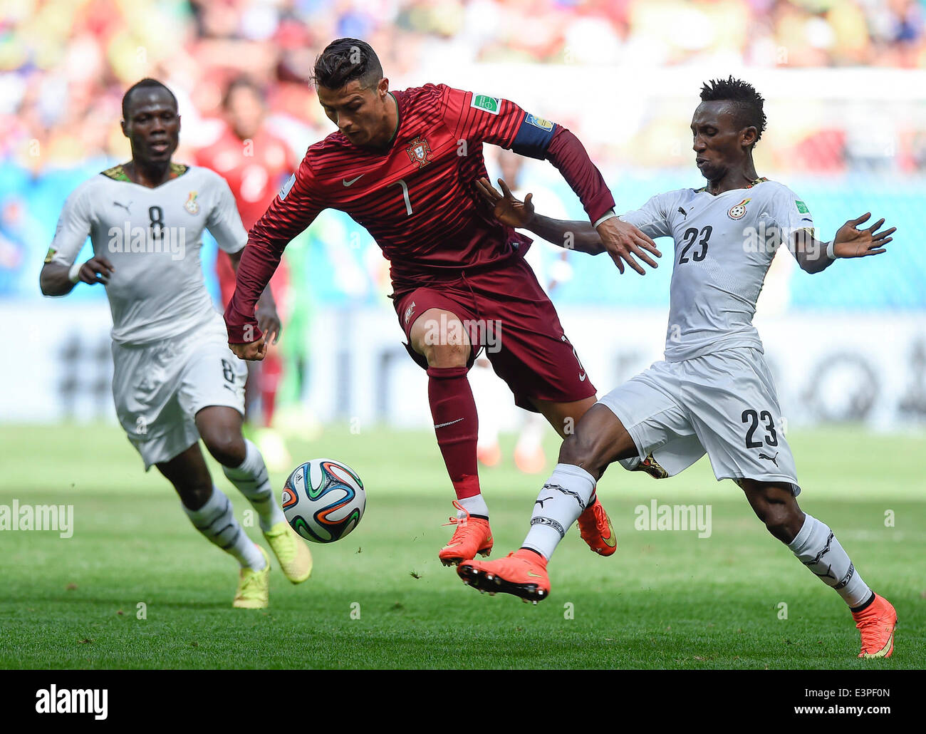 Brasilia, Brazil. 26th June, 2014. Portugal's Cristiano Ronaldo (C) vies with Ghana's Emmanuel Agyemang-Badu (L) and Harrison Afful (R) during a Group G match between Portugal and Ghana of 2014 FIFA World Cup at the Estadio Nacional Stadium in Brasilia, Brazil, June 26, 2014. Portugal won 2-1 over Ghana on Thursday. © Qi Heng/Xinhua/Alamy Live News Stock Photo